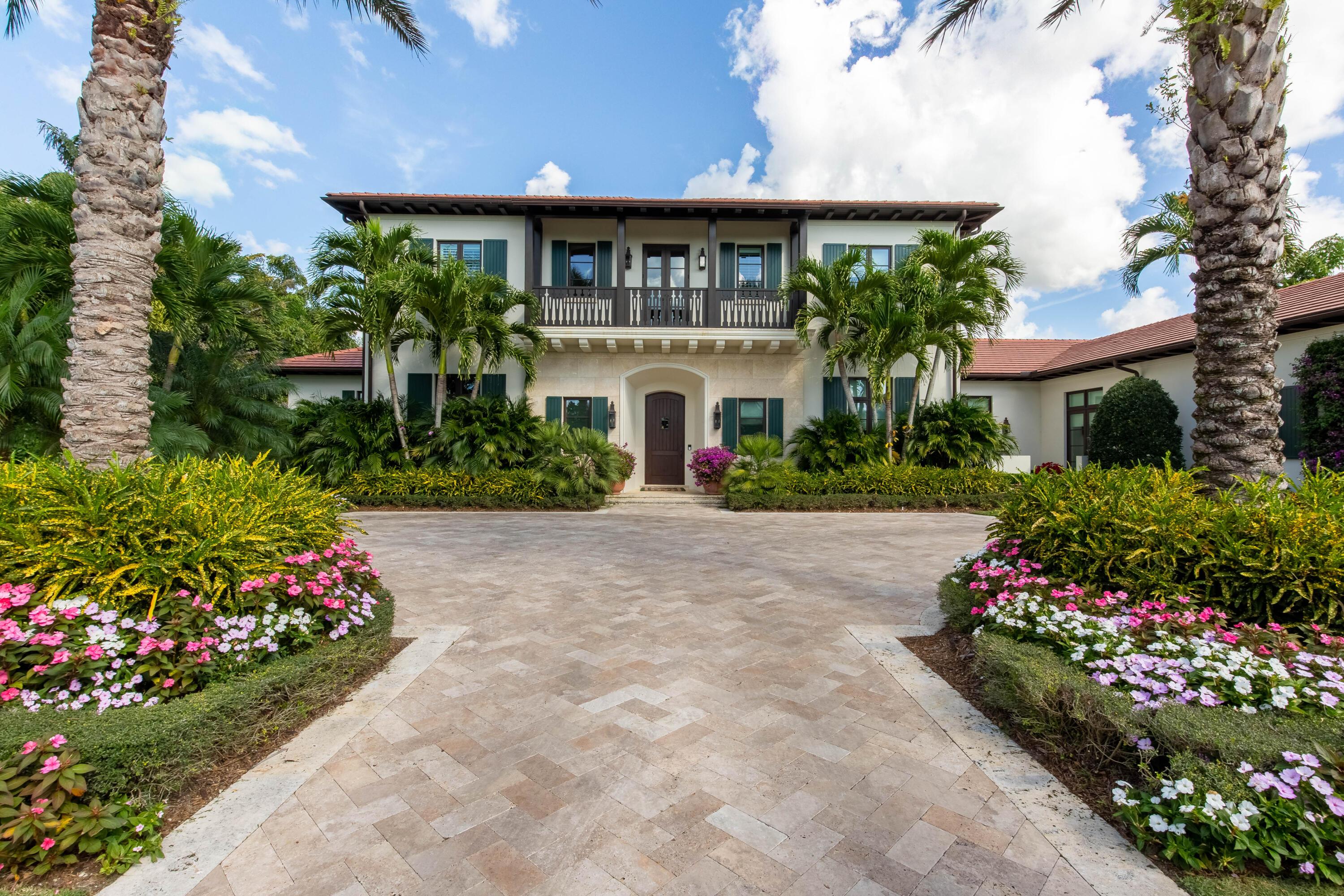 This exclusive Tuscan-styled estate is situated on a waterfront lot in the coveted neighborhood of Cypress Island within the Palm Beach Polo Club. Boasting over half an acre of land, the home overlooks the lake and the 16th green of the championship golf course. Built in 2014, the luxurious estate includes 7,862 square feet of living space, 5 bedrooms, 5 full and 2 half bathrooms, 3-car garage and an exquisite backyard retreat with a modern pool. The property features two privately gated driveways, home generator and impact glass windows and doors throughout. The refined interior offers handcrafted woodwork throughout, lofty coffered ceilings, gorgeous wood and marble flooring, a custom wine cellar and bar, an elevator, fireplace and much more. There is a main level guest suite complete with a private bath and wet bar as well as a second floor suite with access to the expansive balcony with amazing views. The oversized outdoor living area is equipped with retractable screens, outdoor kitchen, fireplace and blissful views.