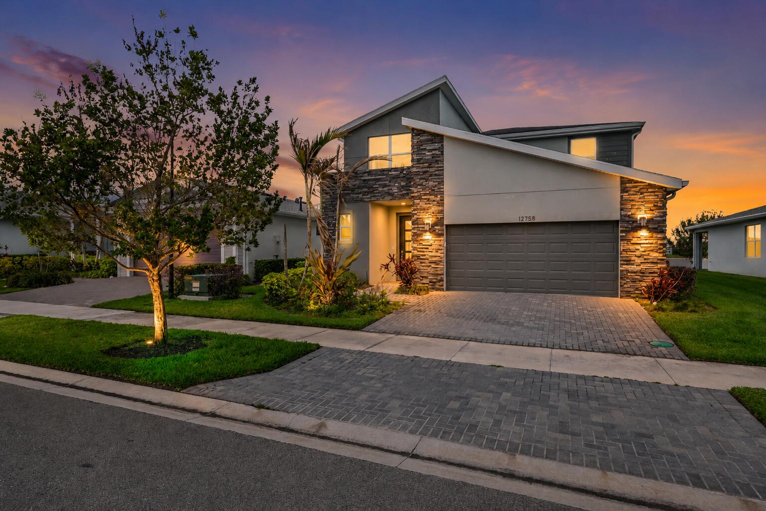 Welcome to luxury lakefront living in the highly sought-after gated community of Emery at Tradition. Built in 2022, this stunning 4-bedroom, 3-bathroom CBS home offers over 2,690 square feet of beautifully designed living space with breathtaking water views and premium upgrades throughout. The heart of the home features a designer chef's kitchen with a large quartz island, natural gas cooktop, stainless steel appliances, custom cabinetry, elegant pendant lighting, and a stylish backsplash, all opening seamlessly to the spacious living and dining areas. Soaring ceilings, abundant natural light, and modern finishes create an inviting atmosphere perfect for everyday living and entertaining.  The first-floor primary suite is a true retreat, offering serene lake views, a custom accent wall, oversized walk-in closets, and a spa-inspired bathroom with a luxurious walk-in shower and dual vanities. Upstairs you'll find generously sized guest bedrooms, a full bath, and a spacious loft ideal for a media room, home office, playroom, or second living area. Step outside to your covered lanai and enjoy peaceful waterfront sunsets overlooking the lake. The oversized backyard offers plenty of room to relax, entertain, or create your dream outdoor oasis. Residents of Emery at Tradition enjoy resort-style amenities including a community pool, fitness center, game room, spa, cable, security, and beautifully maintained common areas. Conveniently located near shopping, dining, medical facilities, golf, and all that Tradition has to offer. This move-in-ready home combines modern luxury, flexible living space, and an exceptional waterfront setting.