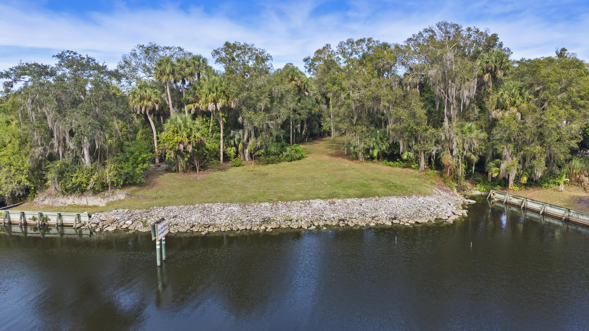 Your waterfront dream home awaits in the River Oaks neighborhood, where a serene nearly one-acre lot with large mature oaks offers direct ocean access and a tranquil setting in the heart of West Martin County's Village of Indiantown. This property boasts convenient access to the Okeechobee Waterway and St. Lucie Canal, providing a navigable waterway connection between the Gulf of Mexico and the Atlantic Ocean. The property's location offers the best of both worlds, being approximately 30 minutes from West Palm Beach, 15 minutes to I-95 via Indiantown Road with connections to the Florida Turnpike, and 30-45 minutes to area beaches like Jensen Beach.