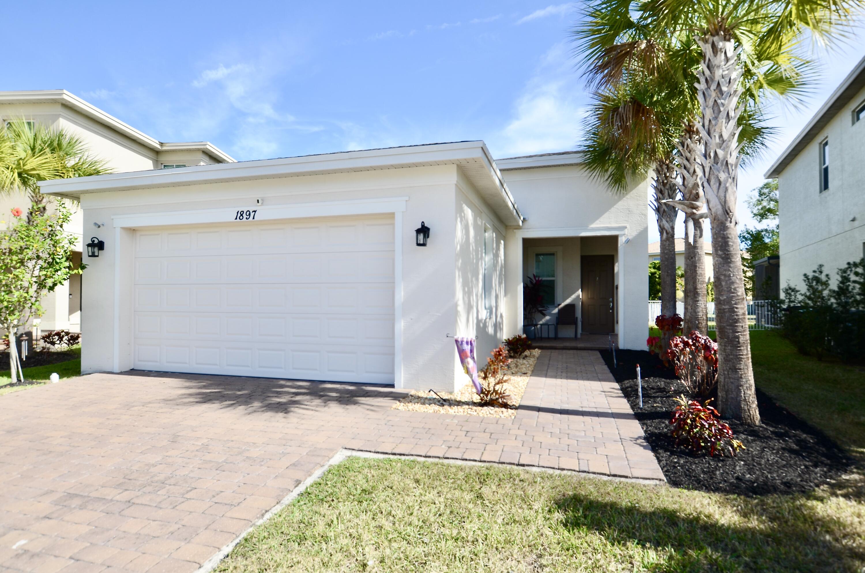 Welcome to this beautifully updated 2021-built home featuring 2 bedrooms, 2 bathrooms, and a versatile flex room/den. Ideally located in the highly desirable St. Lucie West and Torino areas, this home offers abundant natural light, spacious living areas, an open-concept floor plan, and a split-bedroom layout designed for comfort and privacy.  Upgraded features include hurricane impact windows throughout, modern kitchen cabinetry, granite countertops, ample storage space, stainless steel appliances, and beautiful tile flooring in the main living areas. Step outside to your private backyard retreat, where a 4-foot fence encloses a cozy sitting area on the patio overlooking a peaceful lake—perfect for relaxing and enjoying the serene water views. Located in the sought-after Vizcaya Falls community, residents enjoy an impressive array of amenities, including a resort-style pool, clubhouse, fitness center, tennis courts, and playground. HOA dues include access to all community amenities, Blue Stream internet and security services, as well as roaming security patrols, making this gated community an exceptional value.  Conveniently situated just minutes from I-95, highly rated schools, shopping, dining, and all that St. Lucie West has to offer, this home combines tranquility, modern living, and everyday convenience. Don't miss this incredible opportunity!