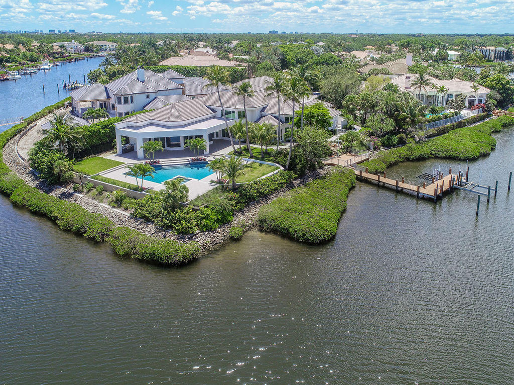 Newly finished Contemporary Estate Home
 on oversized waterfront lot featuring 273' of water frontage creating a 270 degree panoramic view! Located in a private cul-de-sac in prestigious Admiral's Cove of Jupiter, this palatial mansion features over 7,000 SF of living area with 6 bedrooms, 7 and one half baths, 3 car A/C garage, and guest suite w/separate entrance. Deep water canal provides protection for your vessel and allows for up to 150' yacht. Large custom Pool and Spa. Amazing cook's kitchen with 14' magnificent island, wet bar, custom cabinetry, walk-in pantry, built-ins throughout. Master bedroom and bathroom feature dual walk-in garden showers, jacuzzi tub and 2 walk in closets. So many features makes this a ''MUST SEE''. GOLF-TENNIS-BOATING ALL AT YOUR FRONT DOOR!