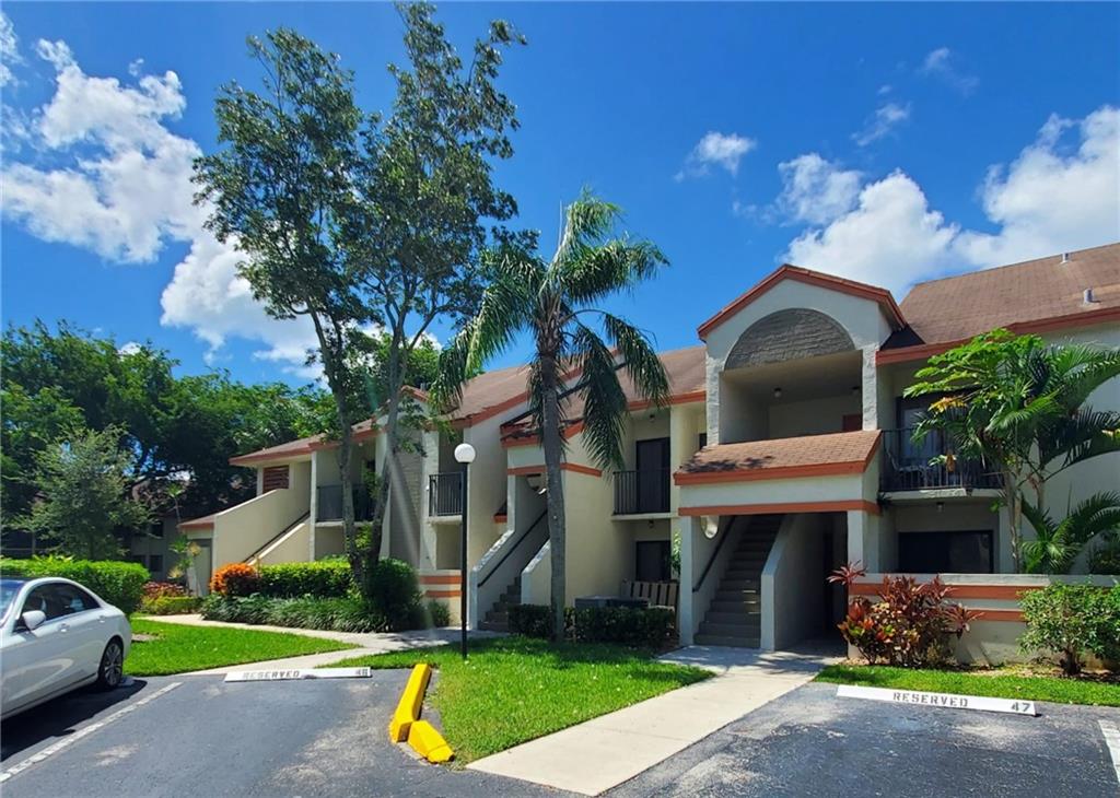 This completely redone condo offers high-end upgrades with extended custom kitchen cabinets, quartz countertops, stainless steel appliances, new washer and dryer.  Large porcelain tiles throughout and waterproof vinyl in bedrooms.  Updated baths w/exquisite finishes.  All new light fixtures.  Custom-built closets.  This second-floor unit features vaulted ceilings, 3 balconies, nice pool views & lots of storage.  New A/C & water heater. Great location in quiet area surrounded by residential neighborhood w/easy access to shopping.  Across the street from city park which offers, tennis courts, basketball, playground and grills.   Pet-friendly community, allows rentals on first year of ownership and offers low maintenance fees (water and cable included).  DO NOT WAIT!  Will not last!