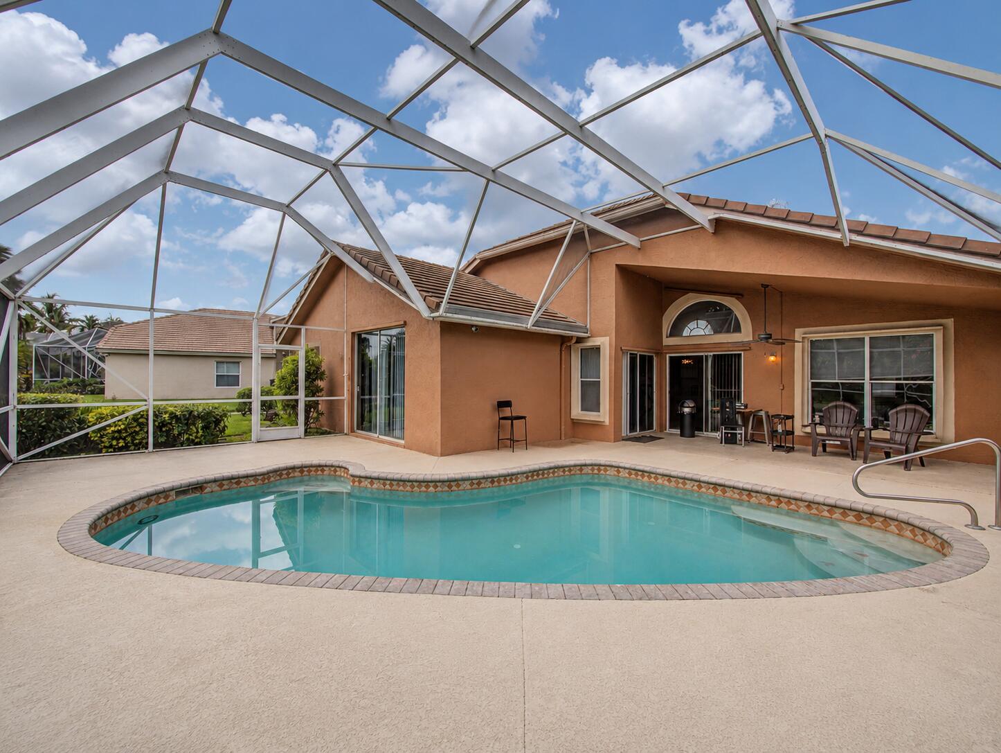 Tucked inside the gated Hidden Creek community of Binks Forest, this Wellington golf course pool home offers the kind of setting buyers hope to find but rarely see available. The home sits along the Wellington National Golf Club fairways, creating a peaceful backdrop with open views, privacy, and a true South Florida indoor-outdoor lifestyle.  Inside, the layout offers a thoughtful balance of connection and separation. The main living spaces feel open and comfortable for everyday living or entertaining, while the primary suite is privately positioned away from the secondary bedrooms. Since purchasing, the seller has enhanced the primary suite with added closet space, giving the owner's retreat improved function and storage.  One of the standout features is the seamless flow to the pool  flow to the pool area, with multiple access points from the living spaces to the outdoors. Whether you are hosting, relaxing by the pool, or enjoying the golf course view, the home is designed to make the backyard feel like an extension of the interior.  Hidden Creek offers a sought-after Wellington location within Binks Forest, known for its gated setting, golf course surroundings, mature neighborhood feel, and convenient access to Wellington's shopping, dining, parks, equestrian venues, and everyday amenities. If you have been waiting for a Wellington home with views, privacy, a pool, and a layout that lives well, this one is worth seeing in person.
