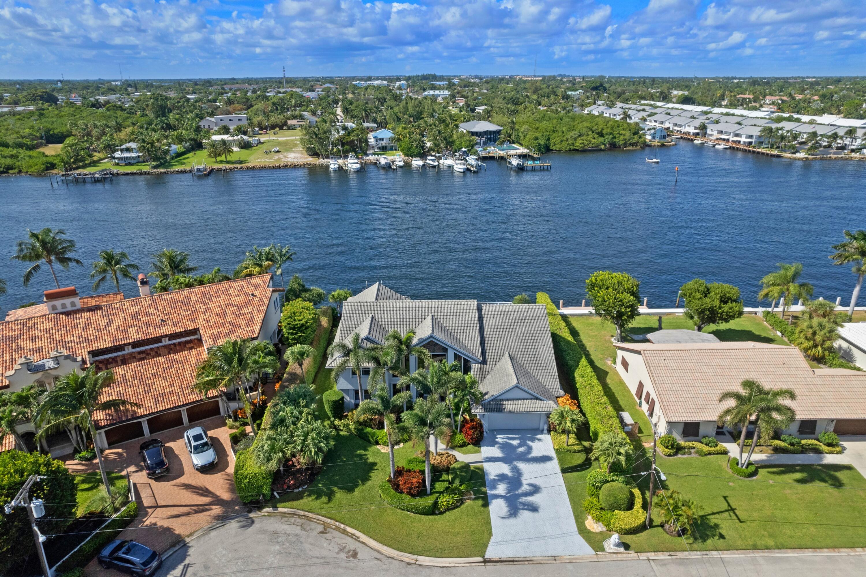 Introducing a spectacular property in Ocean Ridge, this wonderfully maintained direct Intracoastal home offers breathtaking water views from every room. The high ceilings and abundant natural light create a bright and inviting space, while the expansive master suite with a sitting area provides a luxurious retreat. With 3 bedrooms plus a bonus room, including 2 conveniently located on the first floor, this home is perfect for both relaxation and entertainment. Enjoy a short stroll to the nearby beaches and easy access to the Boynton Inlet and Atlantic Ocean for boating enthusiasts. This property boasts 100 feet of water frontage, making it an ideal waterfront oasis. Situated in the exclusive community of Inlet Cay, one of 55 secluded homes, this residence offers privacy and tranquility. With the added convenience of a house generator, this home is ready for you to enjoy the ultimate coastal lifestyle.