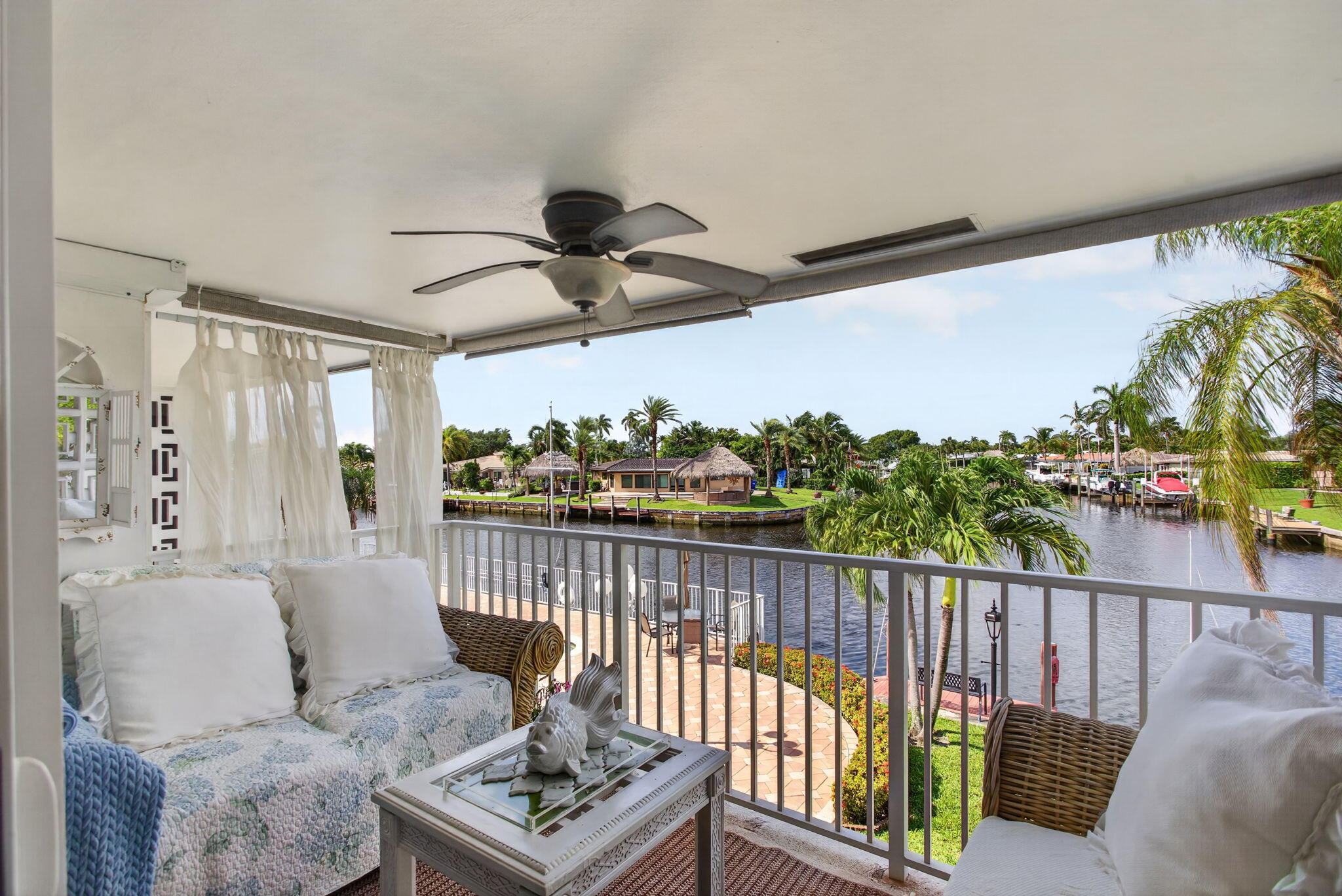 Wake up to breathtaking waterfront sunrises at 800 Pine Dr. #13, a rare second-floor residence in the boutique Pompano Lodge co-op. One of only 18 residences, this 2-bedroom, 1-bath waterfront home offers unobstructed canal views, abundant natural light, hurricane-impact windows, a spacious living area, private storage, and assigned parking. Boating enthusiasts will appreciate ocean access with only two fixed bridges and direct Intracoastal Waterway access. Situated on an expansive 31,000± sq. ft. waterfront property with 323± feet of water frontage, residents enjoy a newly renovated pool and pool deck, rentable boat docks (waiting list), shuffleboard courts, and outdoor recreation areas.  Located minutes from Pompano Beach, dining, shopping, marinas, golf, and entertainment, this well-maintained waterfront co-op offers a peaceful coastal lifestyle in one of South Florida's most desirable boating communities. Land lease through 2063. No pets or rentals permitted.