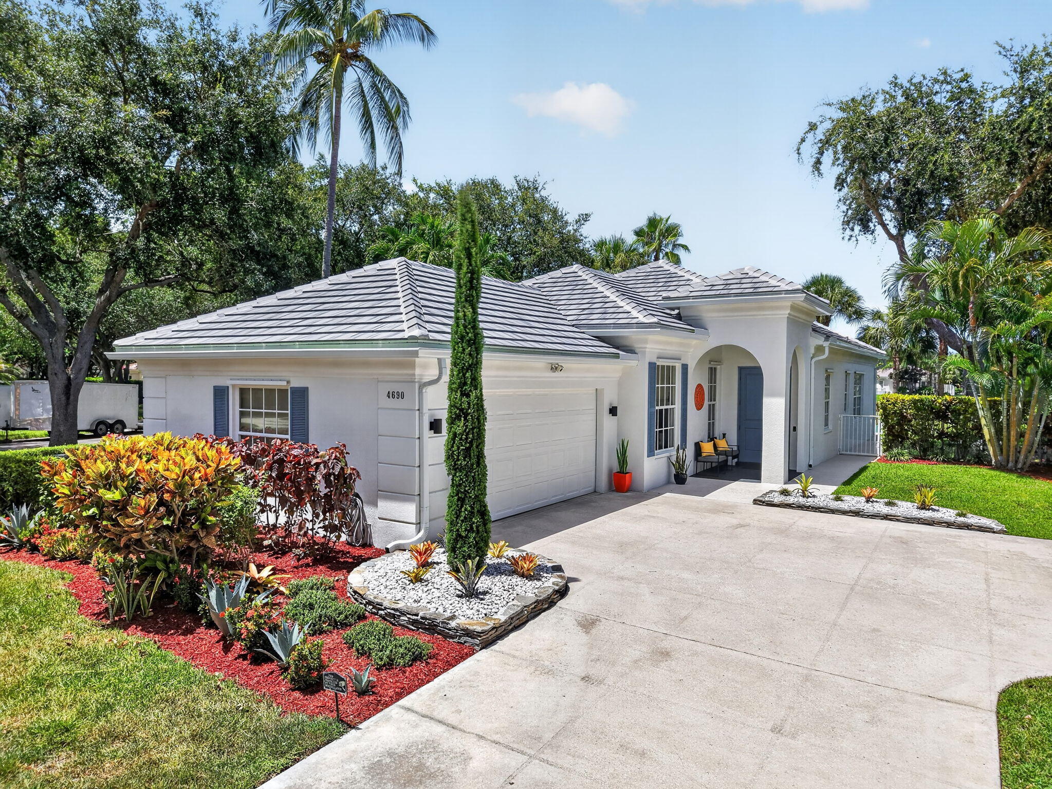Welcome to this beautifully updated 3-bedroom, 2-bath lakefront home, on rare corner lot,  nestled within the quiet, gated community of Hammock Reserve. The open concept living/great room showcases custom built-ins and flows seamlessly into the dining and kitchen areas, creating an ideal space for both everyday living and entertaining. The beautifully renovated kitchen is a dream, boasting sleek white cabinetry, a large pantry, GE Profile stainless appliances, Kohler fixtures, quartz countertops with waterfall edge and coordinating backsplash.  The home features neutral tile throughout the living areas, complemented by wood flooring in all the bedrooms. A desirable split-bedroom floor plan offers maximum privacy. The spacious primary suite is a true retreat, featuring a luxurious modern  ensuite bathroom, plenty of closet space and access to the patio. Additional highlights include a brand-new tile roof (with 7-year warranty), new gutters, fresh interior and exterior paint, a new tankless hot water heater, central vacuum system, Tesla charging outlet, epoxy garage floor, new landscaping with rock beds, and a large laundry room complete with cabinetry and a utility sink. Enjoy relaxing lake views from your private, fenced backyard with large metal gazebo - perfect for entertaining or unwinding outdoors. The front entry door is impact-rated, and the remainder of the home is equipped with hurricane impact panels for storm protection. The community pool is conveniently located just across the street, making it easy to enjoy Florida living year-round. Hammock Reserve is a quiet, well-maintained gated community of just 273 homes featuring a community pool, playground, and scenic jogging path. The location is unbeatable—walking distance to schools and shopping, and just minutes from Downtown Delray Beach, renowned dining, entertainment, and pristine beaches. Don't miss this opportunity to own an updated lakefront home in one of Delray Beach's most sought-after gated communities!