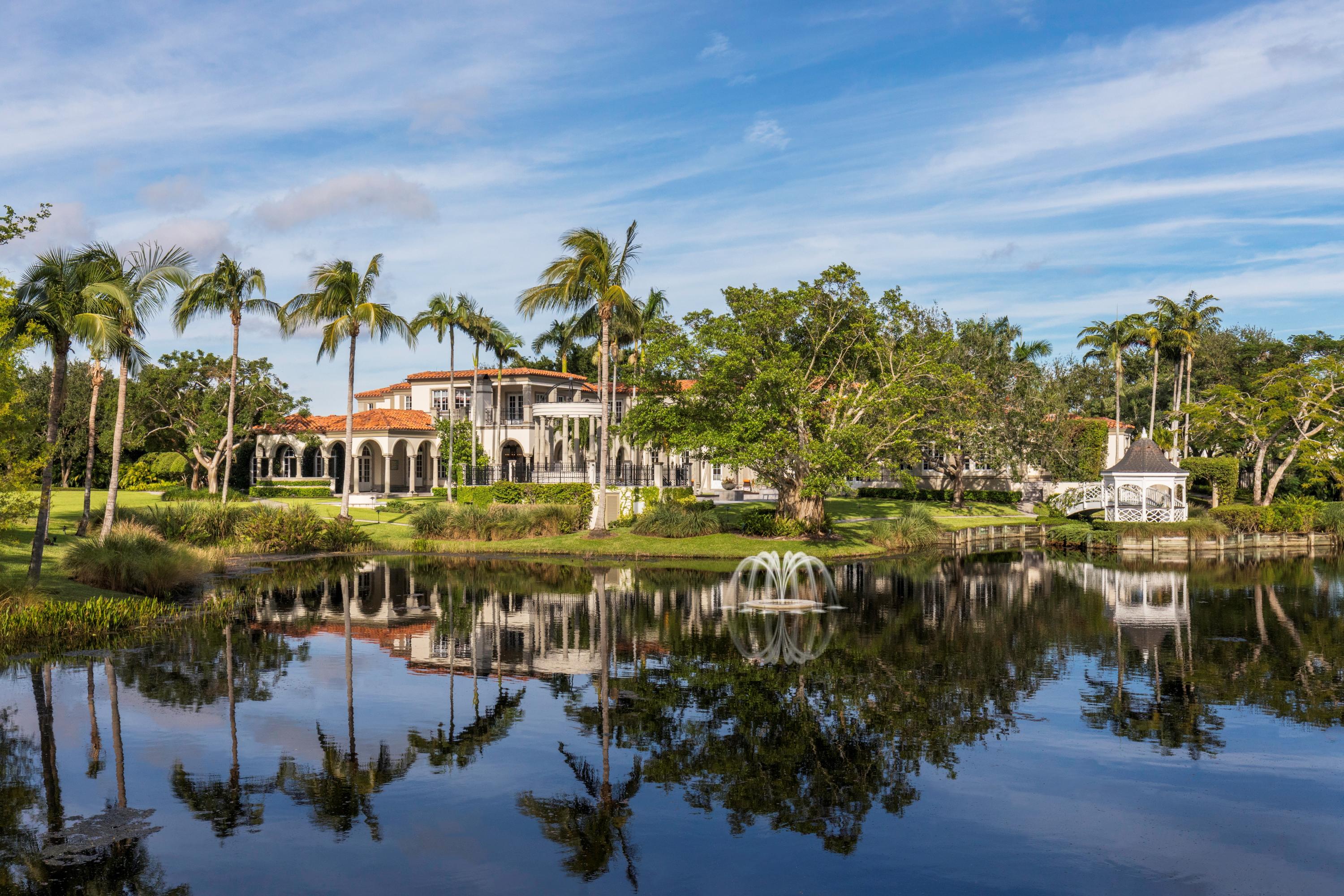 SELLER WILL PAY THE REQUIRED ASSOCIATION 1.5% IMPACT FEE AT CLOSING. The perfect combination of price and value make this Le Lac estate the best offering in Boca Raton this season. Designed by Randall Stofft with exceptional attention to detail and using elegant imported materials the home blends dramatic architecture and craftsmanship to create a truly uncommon haven of total privacy and seclusion. Conveniently poised in central Boca only moments to the boutiques and restaurants of Boca Raton and Delray Beach this magnificent home exudes a grand and elegant style. Sited on a rare 6.65 acres the entrance to the estate is enhanced by stately wrought-iron gates reveling a large circular driveway and Porte Cochere with garages for six cars. The Estate features 23,902 total square feet, of elegance, 9 BR and 8.4BA, grand living room, formal dining room, and a climate control wine cellar capable of holding the most discerning sommelier collection.  The extensive and well-orchestrated gourmet kitchens, with luxurious professional appliances provide the perfect opportunity for hosting small and large gatherings. In addition, the main floor includes a large family room, breakfast room, media/movie center with theater-style seating and cutting edge projector, a two level library with fireplace and mahogany shelving. Tucked away in the south end providing the owner a sanctuary is a sumptuous ground floor master suite with separate siting room, Zen like bath with outdoor Balinese style shower, walk in closets with built in cabinetry, a private balcony just steps  to a bridge that connects to a charming  gazebo completing the retreat like setting. . The sunlit second floor boasts four significant guest suites with sitting areas, a play room with access to a balcony overlooking the breathtaking private lake and gardens. The drama continues with the ingeniously landscaped grounds filled with unexpected textures and appealing lighted walking paths. A private lake, two separate guest houses, Har-Tru clay tennis court, state of the art gym, an awe inspiring pool area with elevated spa encircled by stone pillars and waterfall seamless integrated with a cozy loggia and fireplace. Warm and inviting, refined and casual all describe this exquisite Estate which is fairytale in sight and price...Sure to exhilarate all who visit.