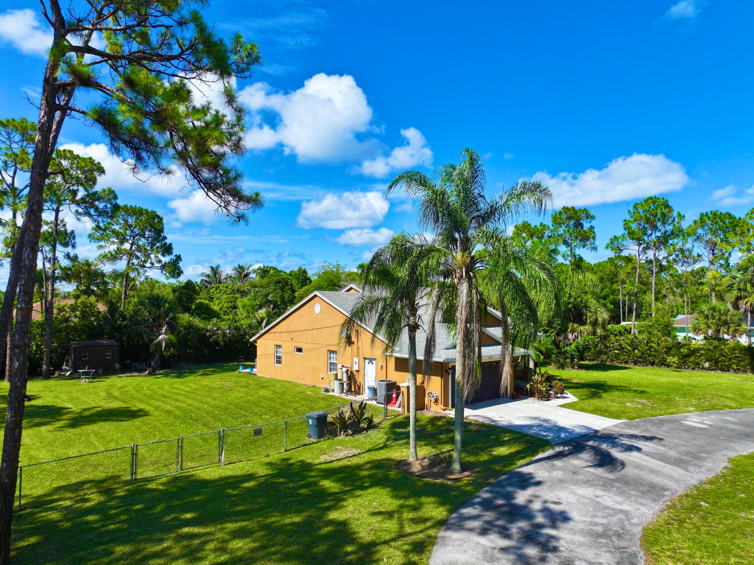 Country living at its best **.  PRICED TO SELL !!!!  PRICED RIGHT !!! RENOVATED KITCHEN WITH QUARTZ COUNTER, STAINLESS APPLIANCES, BREAKFAST BAR**. RENOVATED BATHROOMS **. 14703 71st Place N, The Acreage, FL 33470 1.15-acre lot 3 Bedrooms | 2 Bathrooms **  Approx  2900  total sq ft area ** CBS CONSTRUCTION ** Screened  rear porch 2-car garage No HOA- BRING THE RV, BOAT, TRAILER AND PETS Located in  desirable Acreage/ loxahatchee      Acreage Living at Its Best!   **. LOTS OF ROOM FOR WORKSHOP, GUEST HOUSE, IN LAW QUARTERS AND POOL **. MINUTES TO SHOPPING, BEACHES, ENTERTAINMENT, GAS, , NEW WESTLAKE ER ***.  SCHEDULE YOUR APPOINTMENT NOW FOR- 14703 71st Place N, The Acreage, FL 14703 71st Place N, The Acreage, FL 1.15-acre lot 3 Bedrooms | 2 Bathrooms Approximately 2900 total sq ft  area.  Screened rear porch 2-car garage No HOA Located in The Acreage **     Florida  Living at Its Best!  Welcome to this beautifully maintained 3-bedroom, 2-bath CBS home situated on a spacious 1.15-acre corner lot in the highly desirable community of The Acreage. Offering over 2,000 square feet of living space, this property provides the perfect blend of privacy, comfort, and room to grow.  Step inside to discover a bright and inviting floor plan featuring generous living areas, a well-appointed kitchen, and spacious bedrooms designed for everyday living and entertaining. Enjoy your morning coffee from the screened  porch and unwind in the evenings on the expansive screened rear patio overlooking your private backyard oasis.  With no HOA restrictions, there's plenty of room for boats, RVs, trailers, work vehicles, pets, and all your outdoor toys. The oversized lot offers endless possibilities for a pool, workshop, guest house, or additional storage.  Conveniently located near top-rated schools, parks, shopping, dining, and major roadways while still enjoying the peaceful country atmosphere that makes The Acreage so desirable.  If you've been searching for space, privacy, and freedom without sacrificing convenience, this is the one you've been waiting for. Schedule your private showing today!       Rare Acreage Opportunity - No HOA on 1.15 Acres!    Don't miss this incredible opportunity to own a 3-bedroom, 2-bath CBS home on a beautifully situated 1.15-acre corner lot in The Acreage. Featuring over 2,000 sq. ft. of living space, screened front and rear porches, a 2-car garage, and plenty of room for all your toys, this property offers the lifestyle buyers are searching for.  Bring your boat, RV, trailer, animals, and outdoor hobbies—there's no HOA to limit your possibilities. The expansive lot provides endless potential for a pool, workshop, guest house, or custom outdoor entertaining area.  Enjoy peaceful country living while remaining just minutes from shopping, dining, parks, and top-rated schools. Properties with this combination of land, location, and flexibility are becoming increasingly difficult to find.  Act quickly—acreage homes in this price range don't stay on the market long!