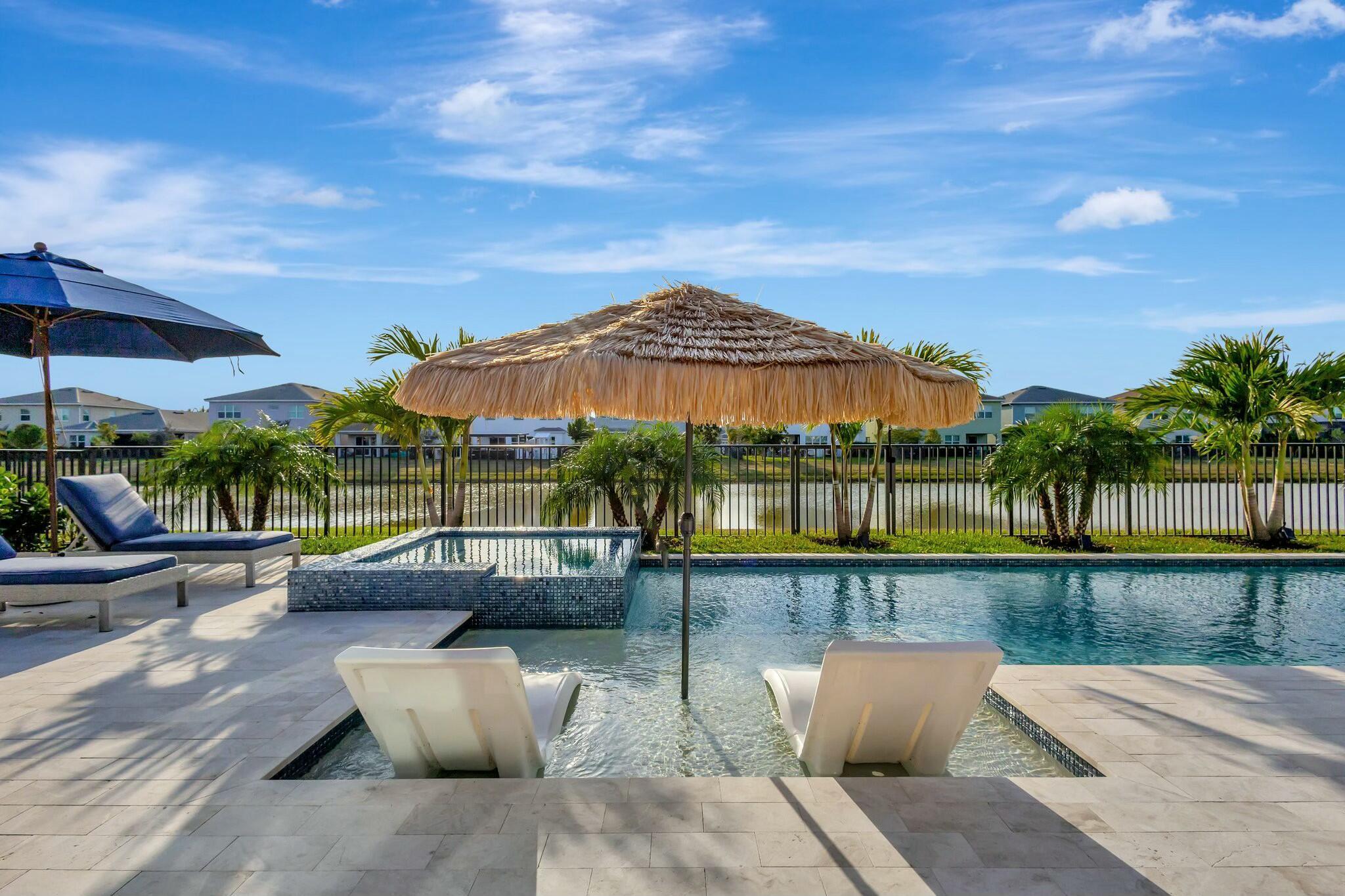 Enjoy lakefront resort-style living with a pool, spa, outdoor kitchen, mature palm trees, and lush tropical landscaping designed for year-round relaxation and entertaining. This 4-bedroom, 4-bath beautifully upgraded home features a gourmet kitchen, dedicated office space, and a luxurious primary retreat with a spa-inspired bath and rain shower. Additional upgrades include a French drain system, whole-home water filtration and softener system, attic stairs with added storage, and a ductless A/C unit in the garage. Move-in ready with extensive post-build upgrades already completed, this exceptional home combines luxury, comfort, and functionality in one of Westlake's most desirable lakefront settings.
