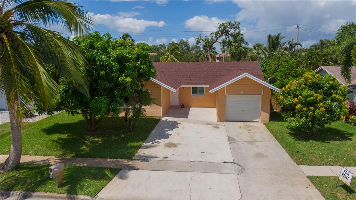 Step into comfort and charm with this beautifully maintained home, perfectly tucked away in a peaceful neighborhood. This inviting residence offers 4 spacious bedrooms and 2 full bathrooms, ideal for relaxing and everyday living.  Enjoy the convenience of a 1-car garage, impact windows for added security, and a screened enclosure—perfect for unwinding or entertaining while enjoying the Florida breeze. The property is enhanced by lush fruit trees, adding a touch of nature right in your backyard.  Inside, you'll find a freshly painted interior complemented by stylish tiled floors throughout. The updated kitchen shines with granite countertops and elegant wood cabinetry, creating a warm and functional space for cooking and gathering. A washer and dryer are also included for your convenience.