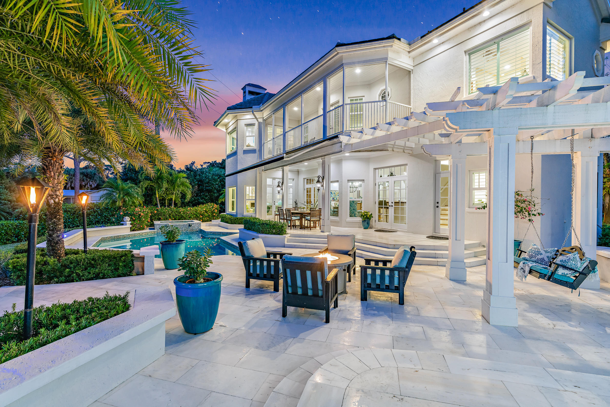 If you're thinking ''WHOA, can this property be REAL?'', we have great news for you -- It IS real, and it is available now, just in time for Spring 2021! 8319 SE Rivers Edge is one of Jupiter's finest waterfront properties. Comprised of two spectacular residences - the 5,500 sq ft main home and 2,000 sq ft guest house - on one magnificent, sprawling 2.3 acre fully fenced & gated private property. ''Riverdance'' (as affectionately called by the original builder) was inspired by design elements found in coastal Virginia and along the Carolina coastline, and has everything you would want in your perfect home in the Palm Beaches. 

Riverdance features two full residences on one unique, sprawling property -- the 5,500+ sq ft main house and the 2,000+ sq ft carriage house and [Click to Read Mo enough garage space to hold 10+ cars between the main home and carriage house. Additional exterior features on the property include a sparkling pool & spa with new pool pump & heater, and spectacular marble pool deck and patio, retractable awning, fire pit, gas tiki torches, 115 ft of manicured waterfront with 270 degrees of privacy and views, a freshly painted (premium non-slip & durable coating with 10 year warranty) dock with electric and water, a covered 16,000 lb boat lift (YES! Covered boat lift is allowed in Jupiter! Lift currently holds a beautiful 32 ft Whaler "Vantage" - also for sale - contact listing team for more information), a brand new floating kayak dock, outdoor summer kitchen with new Lynx grill, and enough room to add a tennis court!  The exterior features at this property are truly endless - the current owner has cared for the home meticulously and has all kinds of fun additions throughout the property including reciprocals for holiday lights, magnificent landscape uplighting, hot water spigots for washing cars, and dozens of other features. 

MAIN HOUSE:  The main house is a masterpiece of both design and function, featuring an elegantly open floor plan with both formal and casual living spaces, exquisite designer finishes reminiscent of Coastal Virginia and the Carolinas, but with a distinctive Palm Beach flair, curated by an acclaimed local designer. The home is being offered fully furnished, although it can be purchased unfurnished. 

Renovated in 2018, this home has been meticulously cared for, with pride of ownership felt throughout the home from the moment you pull up to the elegant gate, and wind down the property's magnificent tree lined driveway.  

The Main House was designed with the entertainer in mind with a spectacular gourmet chef's kitchen (gas range!), and large butler's pantry / service kitchen anchoring the main living space featuring double ovens, double dishwashers, plate & bread warmer, double refrigerators, double freezers, double sinks, a water filtration system, trash compactor, and walk-in pantry.  
The kitchen's woodwork and millwork are a work of art and is perfectly contrasted by the home's freshly painted crisp, white trim and walls. 

Four large bedrooms can be found upstairs (one currently setup as the second office) - all with generous sized closets, high ceilings, spectacular natural lighting, and waterfront views for days.  The master bedroom is a masterpiece in itself with a huge en-suite sitting room (could be a queen's closet!), wetbar, and his & hers closets. 
Other luxuries in the Main House include TWO laundry rooms - one upstairs and one downstairs making the South Florida lifestyle effortless, a walk-in wine "cellar", and fireplace & mantel in the Florida Room / sitting room overlooking Loxahatchee's peaceful waterfront. 

CARRIAGE HOUSE
The Guest House (or "Carriage House") is a two-level, 2,000+ square foot, three bedroom home, with a HUGE garage space underneath and an ADORABLE living space on the second floor. With three bedrooms, including a master suite, an open floorplan, new kitchen (hello butcher block countertop!), designer lighting, and the ceiling beams from your DREAMS, this guest house is the icing on the cake of this picture perfect property. 

Privacy, luxury, and elegance are all words that come to mind when thinking about Riverdance.  Come see this magnificent home today before it is too late!