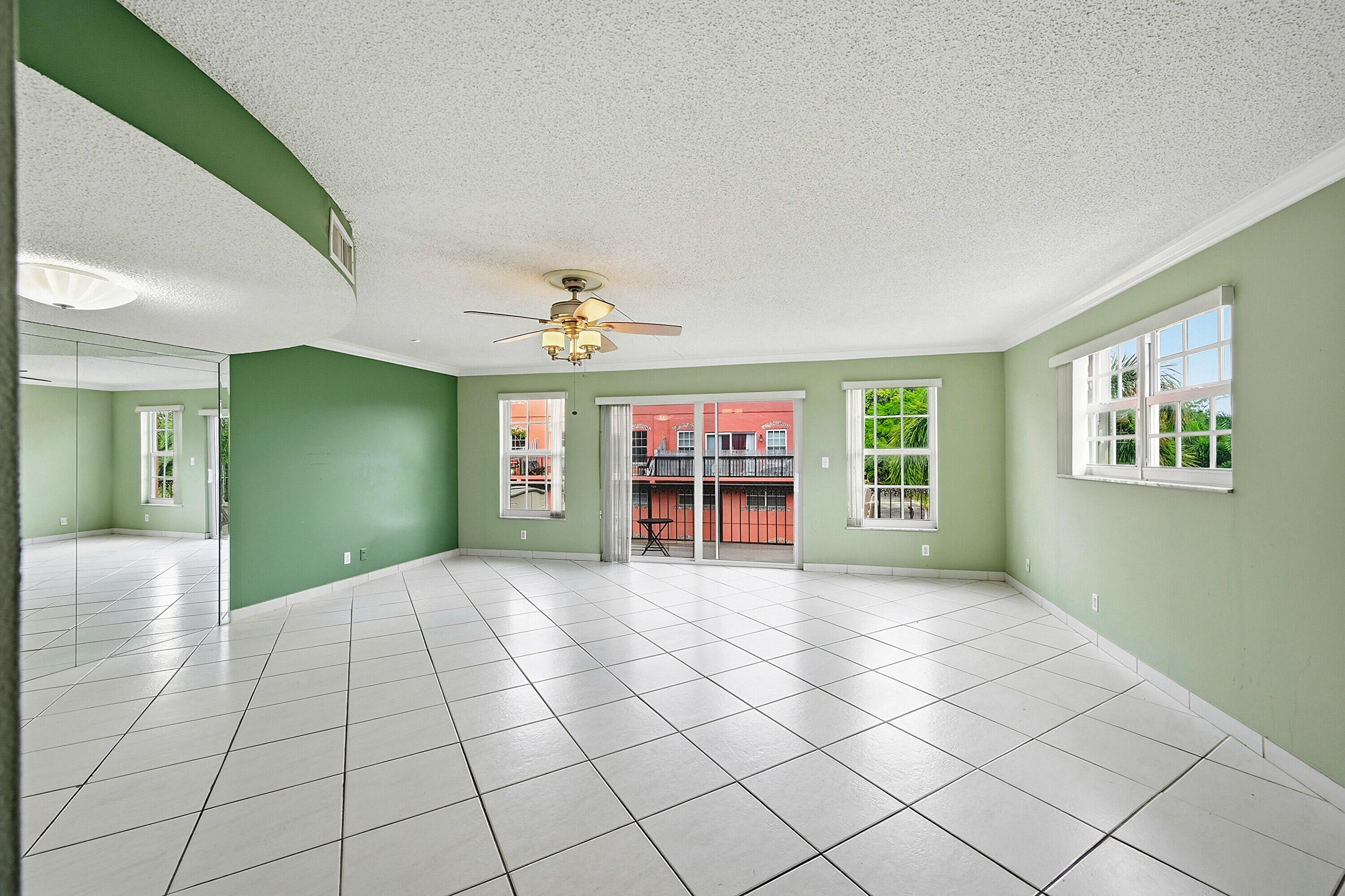 This spacious , updated corner 3/2/1 townhouse apt. is located at the famous Tennis Club of Ft Lauderdale & has been converted into  a 2 BD (both large ) 2.5 BA. Hurricane Impact windows throughout, with tiled floors downstairs & natural wood floors upstairs. Kitchen has S.S. appliances, recessed lighting, self closing drawers & granite counter tops, plus stackable washer & dryer & tankless water heater. The large bright Living Room has crown molding ( as does the Master BD ), leading into a large private balcony. All bathrooms have been updated also.Closest bldg.. to all amenities--20 Clay Tennis Cts., (10 Lighted), 3 Hard Cts., Heated Pool, Spa, fully equipped Gym, full service Patio Bar & Grille - Gated Community, manned 24/7 Security makes you feel safe. Close to beaches, Wilton Manors