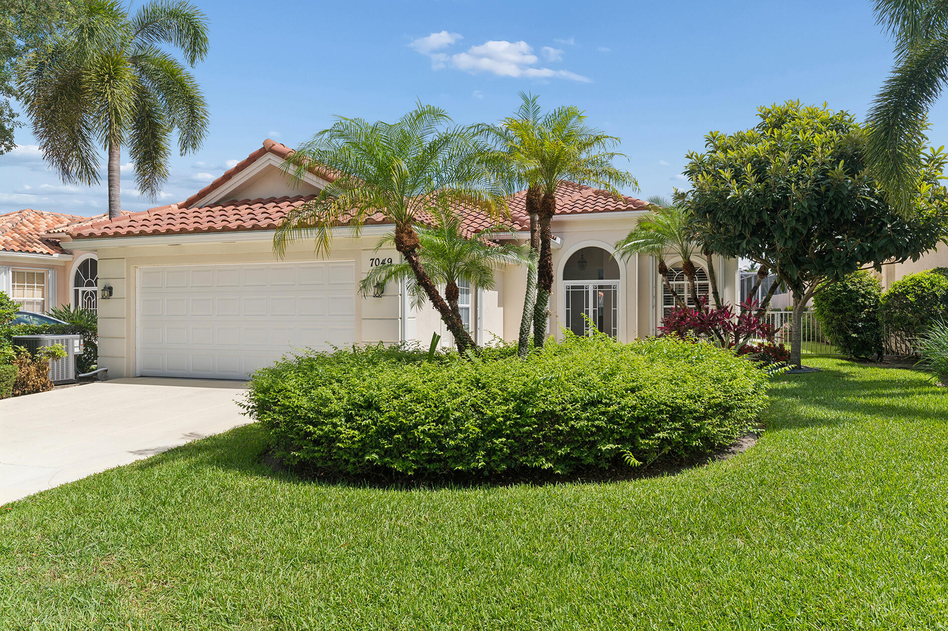 It's in Move-in Condition, It's Ready for one Lucky Buyer to Enjoy the Florida Lifestyle & It has All the Must Have Features! But Wait, there's Still more! There's a Newer Roof (2022) with a Transferable 12-year Warranty, a Gorgeous, Custom, Heated Swimming Pool & Spa in a Screened Terrace, that Sparkles in the Florida Sun! These & so many More Reasons make this Lakeside, Pristine Oakmont, A Must See! In the Fantastic 24 Hour Manned Gated Community of Riverwalk! One of the Best Locations in Palm Beach County, 15-20 minutes to Everything including Palm Beach, the Ocean & Airport! The Extra, Wide Newly Landscaped Lawn with Lush Tropical Plantings leads to the Double Door Screened Entry, that Opens to the Gracious Foyer with A Stunning Antique Chandelier, that along with the Main Rooms of the Residence, (The Great Room, Dining Room, the Den, Kitchen & the Hallway have Breathtaking 20 Inch Porcelain Tile Floors, that will be compatible with Any Decor), Leading to The 24 Ft. Living Room with a 12 Ft. Ceilings, a Ceiling Fan, & a Custom Built Real Wood Entertainment Wall, that leads to the Open & Airy Dining Area with a Unique Chandelier, that has a Set of Sliding Glass Doors ( with Plantation Shutters) leading to a Secluded Garden Patio, that would be perfect for Grilling & there are also 18 Feet of Sliding Glass Doors (Great Room & Dining Area) Leading to 22 Ft Covered Lanai with Two New Paddle Fans/Fixtures, that leads to the Screened Enclosure with a Custom Heated Designer Swimming Pool & Spa with a Newer Pool Heater, Pump, an Automated Pool Remote App.& Awe-inspiring Views of the Azure-Blue Lake! There is a Den/Office with two Clerestory Windows with Custom Plantation Shutters, Built-in Bookcases & a Newer Ceiling Fan! Perfect for Today's, Stay at Home, Telecommuting Workforce! that opens to the Foyer as well as to the Kitchen, The Hub for Casual Entertaining & Everyday Living, that has been Totally Refreshed & Updated with Newer Cabinets with Drawers, Pull-out Shelves, Gorgeous Quartz Countertops, Wide open Space over the Breakfast Bar but, with Additional Cabinets Below the Counter & Added Corner Cabinet Storage; Open to the Great Room,  All Newer GE Profile Stainless Steel Appliances including a French Door Refrigerator, a Dishwasher, a Double Oven Range with 5 Burners, Microwave, A Separate Beverage/Wine Refrigerator & an Oversized, Single, Deep, Well Stainless Steel Sink & a Custom Newer Faucet! The Newly Carpeted Master Suite is Private, Secluded & has Crown Molding, A Ceiling Fan, Sliding Glass Doors with Plantation Shutters that lead to the Screened Outdoor Entertainment/Pool Area, a Dressing Area with 4 Closets including One Walk-in, with Shelving & Hanging Space, 2 Double Width Closets, all with the same Shelves & Hanging Space, A Linen Closet Plus the Ultimate Luxury, 2 Ceramic Tile Baths, One with a Soaking Tub, an Extra Long Vanity with a Sink with a Newer Faucet & a Separate Make-up Counter with Mirror & the other with Newer Tile Wainscoting that carries through into & Surrounds the Gorgeous Extra Large Shower with a Contrasting Glass Tile Feature Row, 2 Seamless Glass Door, a Vanity with a Newer Faucet & a Newer Comfort Level Toilet! The Bedroom Wing consists of 2 Large Newly Carpeted Large Bedrooms with Ceiling Fans, Closets with Built-ins, a Full Ceramic Tile Bath with a Vanity & a Built-in Ceramic Tile Tub & Shower with a Glass Enclosure & a Ceramic Tile Utility Room/Butler's Pantry that has Extra Cabinets with a Laundry Sink & a Newer Full Size Washer & Dryer with Pedestal Drawers, that leads to the 2 Car Garage with A Newer Faux Terrazzo Floor & a 220 Volt Power Outlet for Electric Vehicles! The Side Yard is Fenced with 2 Gates!  There's a Newer (2025) Rheem HVAC & a Newer (2024) American Hot Water Tank! There are Accordion Hurricane Shutters on all the Openings, including the Entire Lanai & A Central Vacuum!  The Roof was cleaned with a Complete Spray Tech with a 2 year Warranty on the Roof-A-Cide Treatment! The 600 Acre Community is Incomparable having 200 Acres of Lakes, 12 miles of Pedestrian Walkways with Cobblestone Bridges, Park Benches & Street Lamps! There is a Roving Security Patrol, an Exclusive 24 Cable Channel to find out what is going on & there is a lot! The Town Center, the Heart & Soul of the Community has All The Amenities including 3 Heated Swimming Pools (1 Lap Pool, 1 Adult & 1 Resort), 6 Har-Tru Lighted Tennis Courts, 4 Lighted Pickleball Courts with an onsite USPTA Pro on Staff & a Pro Shop, a Fitness Center, a Bocce Court, a Tot Lot, a Post Office, Plus the Acclaimed "Centanni Cafe", a Genuine Italian Restaurant in the Town Center, run by a Chef with over 25 years Experience in Italian Cuisine with Outdoor & Indoor Dining overlooking 3 Lakes for your Dining Pleasure serving Lunch, Dinner & there will be Special Parties on Holidays too! There are also Takeout & Catering Services! These Service & Amenities are included in the HOA! Plus, the grounds of the property, front & back are taken care by the HOA Fee plus so is the Newly Upgraded X-finity Platform Comcast Cable & Internet Service! It is like Living in a 5 Star Resort, 365 days a year! Sit Back, Relax & Enjoy Living in the Ultimate Florida Lifestyle Community! You will never want to Leave! This One-of-a-Kind, Fenced, Lushly & Tropically Landscaped Lakefront Updated & Refreshed Oakmont with A Newer Roof, A Fabulous, Heated Swimming Pool & Spa, is waiting for One Lucky Buyer to Call Home But, not for Long!