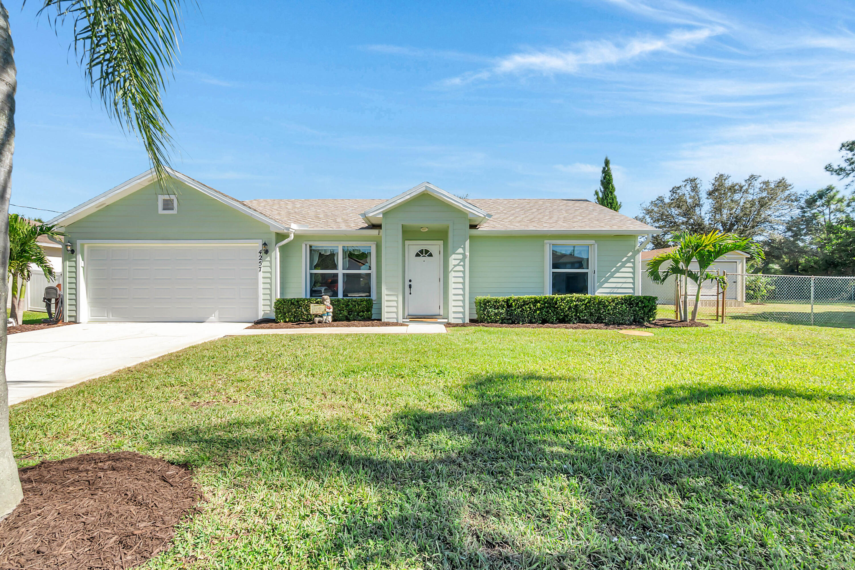 Welcome to this beautifully updated 3-bedroom, 2-bathroom home set on a rare double lot—each lot about a quarter acre. The additional lot is directly adjacent to the main home and is already prepped for building, potential for expansion, guest house, additional house or investment property. This home features brand-new roof installed in 11/2025 and ceramic tile flooring throughout, providing a clean, cohesive look and easy maintenance. The back windows are thermal, and hurricane shutters are installed on all windows, adding comfort, safety, and energy efficiency. Step into the upgraded kitchen, complete with soft-close cabinets, modern finishes, and beautiful lighting that continues throughout the entire home. All appliances recently purchased. This is truly a turnkey/move in ready home.