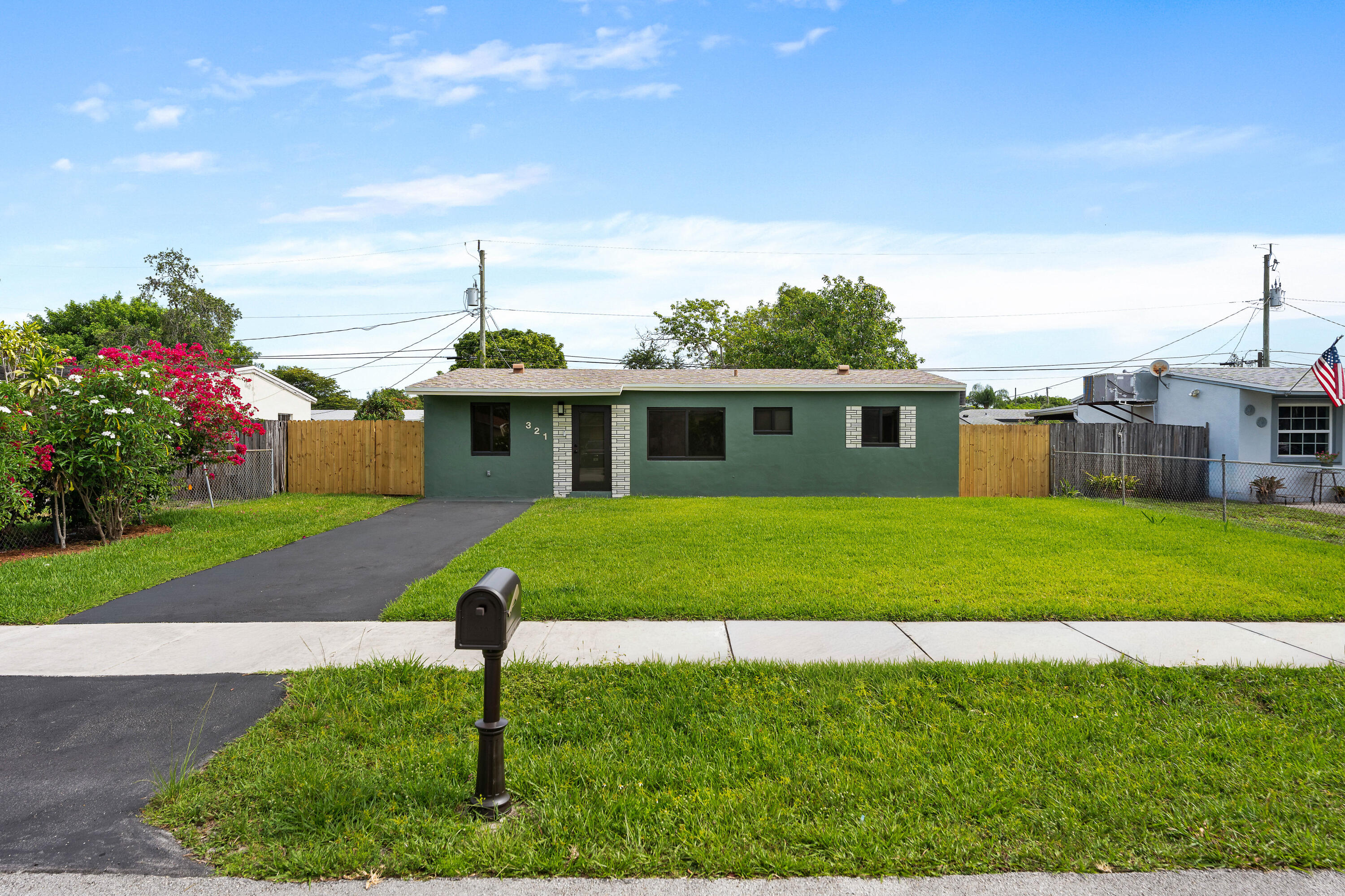 This beautifully renovated 3BD/1BA home combines modern upgrades with South Florida living—and NO HOA. Major improvements include a brand new roof with transferable warranty, hurricane-impact windows and doors, tankless water heater, and a new washer/dryer.  Inside, you'll find luxury vinyl flooring throughout, recessed lighting with dimmers, fresh paint, new doors and closet systems, and a stunning kitchen with quartz countertops, new cabinetry, backsplash, and appliances. The fully renovated bathroom features stylish finishes and updated fixtures. Enjoy a fully fenced backyard with mature avocado and mango trees, fresh sod, and plenty of room to relax or entertain. Located only 10 minutes from the beach!