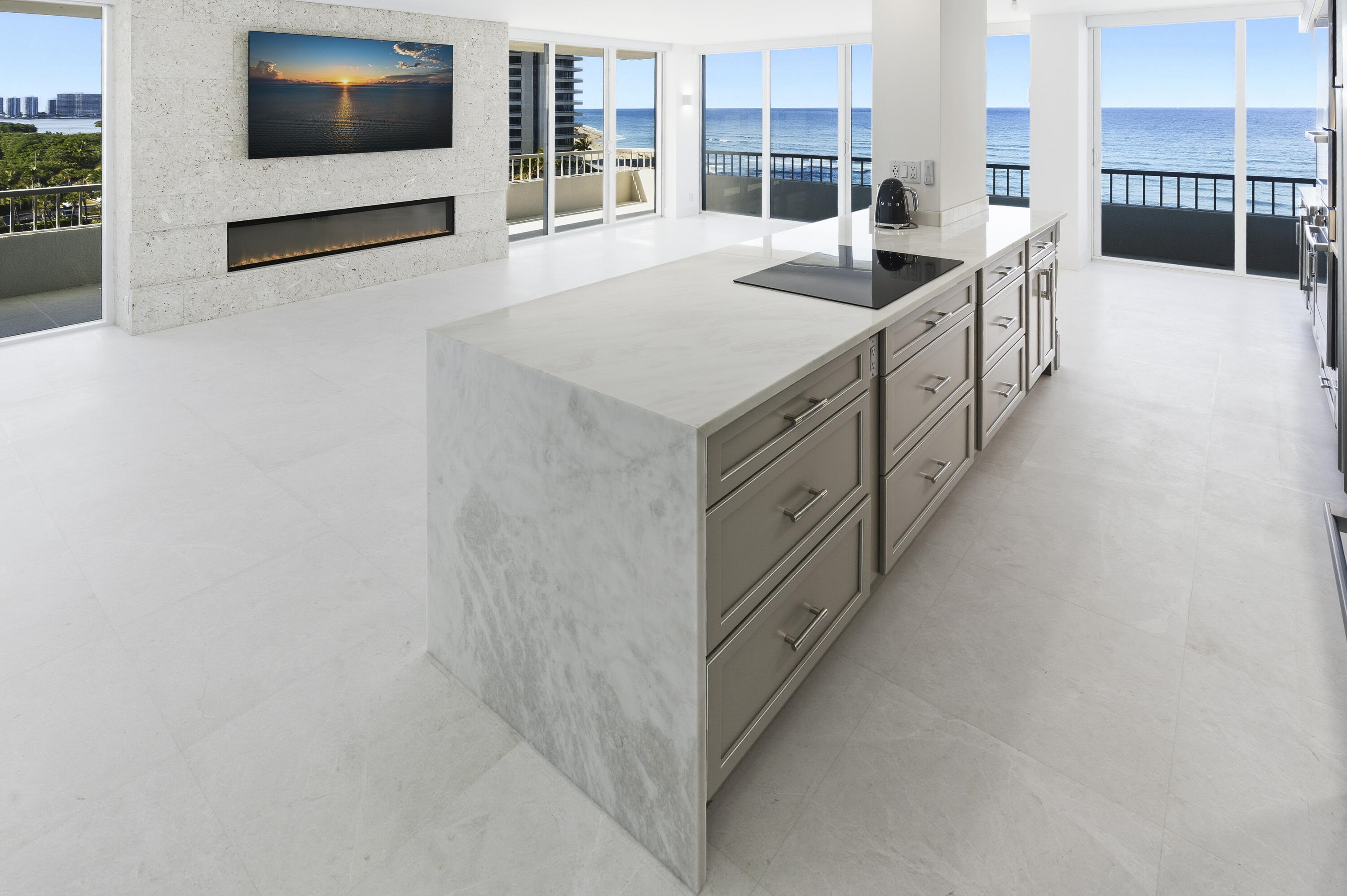 Experience luxury living that will exceed your expectations! Panoramic oceanfront living in one of the most desired buildings and stacks at Water Glades! Experience a lavishly designed & decorated 7th floor residence where sunrise and sunset are viewed from expansive floor-to-ceiling high-impact glass. This 2-bedroom, 2-bathroom condo offers the best of both worlds, with breathtaking oceanfront and intracoastal views. The total custom-designed and completely renovated apartment includes only the finest quality materials, built by one of the premier builders in the area. The residence, completed with Level 5 finishes throughout, features honed snow-white marble floors, a striking natural coral stone fireplace, and walls of floor-to-ceiling impact glass and sliders opening to a wrap-around balcony with direct ocean and intercoastal views.  

The living space is anchored by a rare natural coral stone fireplace, creating an inviting focal point that is almost unheard of in oceanfront condos. The kitchen is highlighted by White Mystery marble countertops, a Carrera marble backsplash, and custom glazed cabinetry, complemented by a full suite of Bosch appliances. The primary suite offers a custom closet system and a spa-inspired bathroom with Crystallo countertops, double sinks, custom cabinetry, and a white glass stone tile shower. The guest bathroom mirrors the same elevated design with Crystallo stone in the shower, counters, double sinks, and custom cabinetry. 

Additional upgrades include electric blinds throughout, a full-size Electrolux washer/dryer, 3 Sony televisions already in place, and custom-made barstools.

Water Glades is located on the preferred north end of Singer Island, directly on the ocean, spanning over 11+ acres and 1,025 feet of private beach, and beautifully manicured grounds resting beside MacArthur State Park, offering privacy and protected natural beauty. Minutes from Palm Beach Gardens, PGA Boulevard, Worth Avenue, and Palm Beach International Airport, it delivers elevated privacy, polished ease, and effortless access to everything that matters.
Residents enjoy two heated pools, private beach access, an oceanfront clubhouse with a social room, fitness center, library, tennis and pickleball courts, on-site management, and a 24-hour manned guard gate in a secure oceanfront community. Unit comes with a Covered Parking Space.