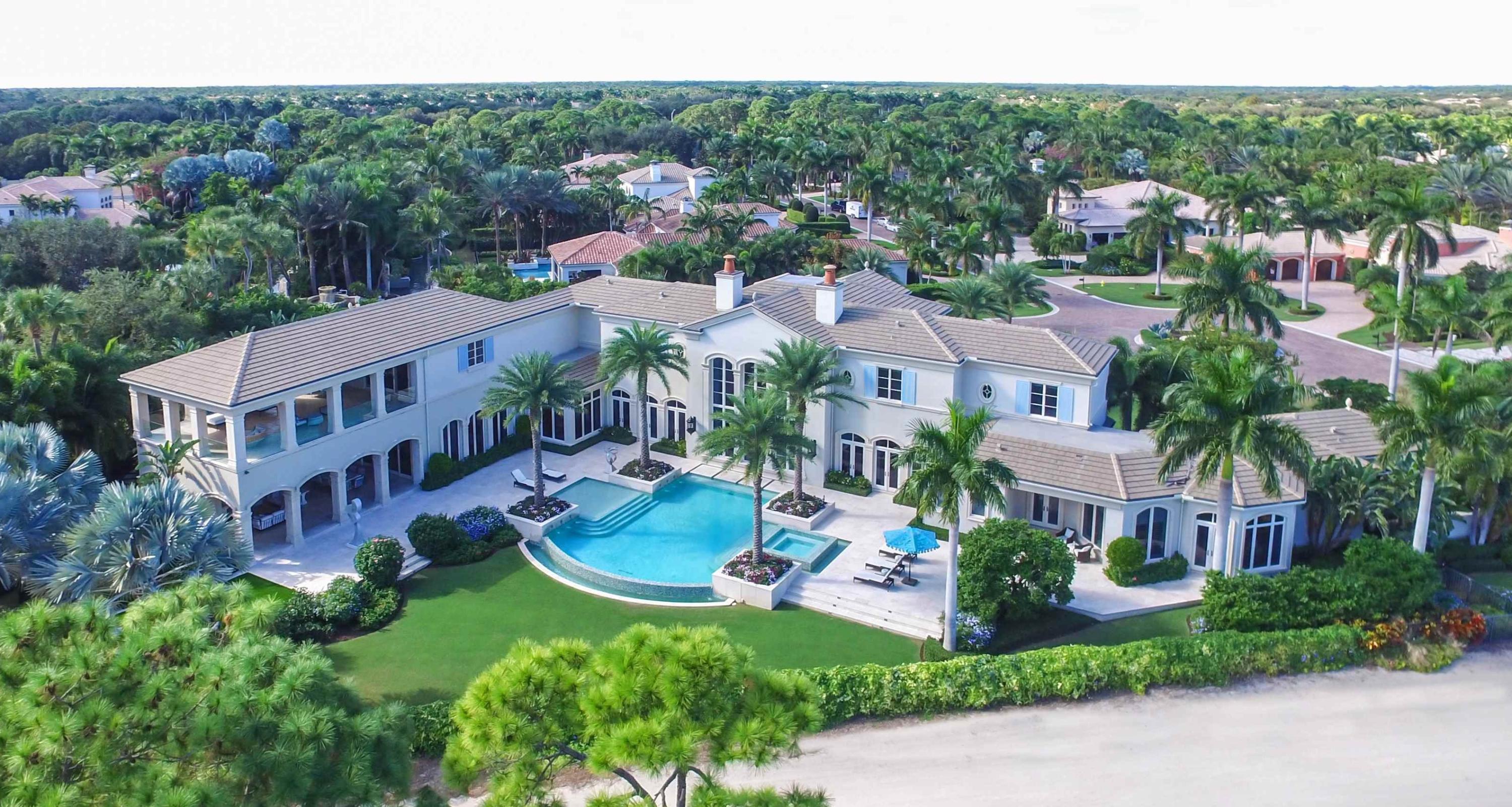 Exceptional views from this custom estate home situated on the finest lot in prestigious Old Palm. Stately and elegant, this thoughtfully designed home exhibits glamour and luxury, built with the finest finishes. Spaciously designed with great attention to detail, 6 bedrooms, 8 fulls baths, 1 powder room, a library, and a theater comprise this masterpiece. The Master Suite is fit for royalty with two grand baths and two room size walk-in closets. Guests will enjoy their upstairs retreat with a private living area and balcony that boasts extraordinary views. The outdoor living space is resort like with its infinity pool, outdoor fireplace and fabulous lounging areas.