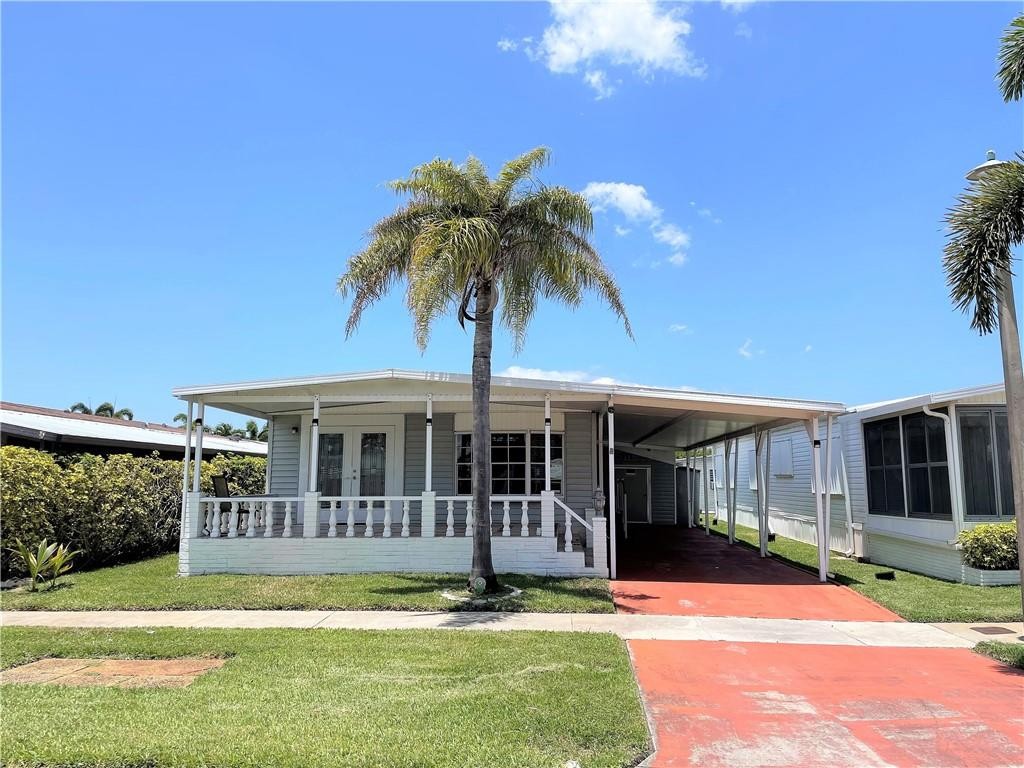 Absolutely gorgeous 2/2 double wide with carport - beautifully tiled open porch/patio - shed - -updated kitchen with granite counters-wood cabinets- stainless appliances - -washer and dryer is in house - -tile floors throughout house - -priced right for quick sale - -truly a must see  *****Note:  Buyer has to pay a $2,500 capital contribution fee to the assoc. at closing*****