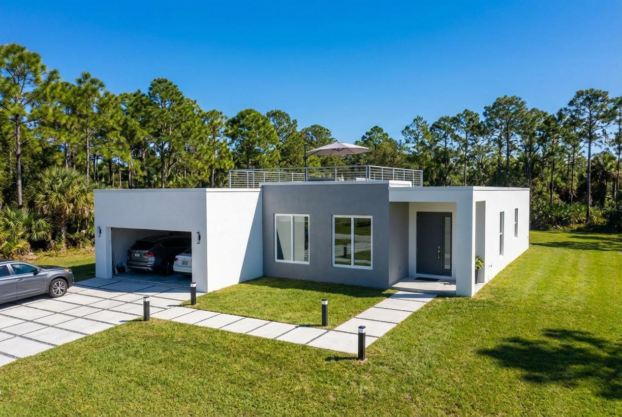 Modern new construction pre-manufactured home currently under development with completion expected in the coming months. This thoughtfully designed residence features clean architectural lines, open living spaces, and large windows providing abundant natural light. The open layout includes a contemporary kitchen with quality cabinetry, quartz countertops, and a central island connecting the living and dining areas. The primary bedroom includes a private bathroom with modern fixtures and a glass-enclosed shower. Additional bedrooms offer flexible space for family living, guests, or a home office. Buyers who go under contract prior to completion may have the opportunity to select certain finishes and upgrades. Images are architectural renderings for illustration only.