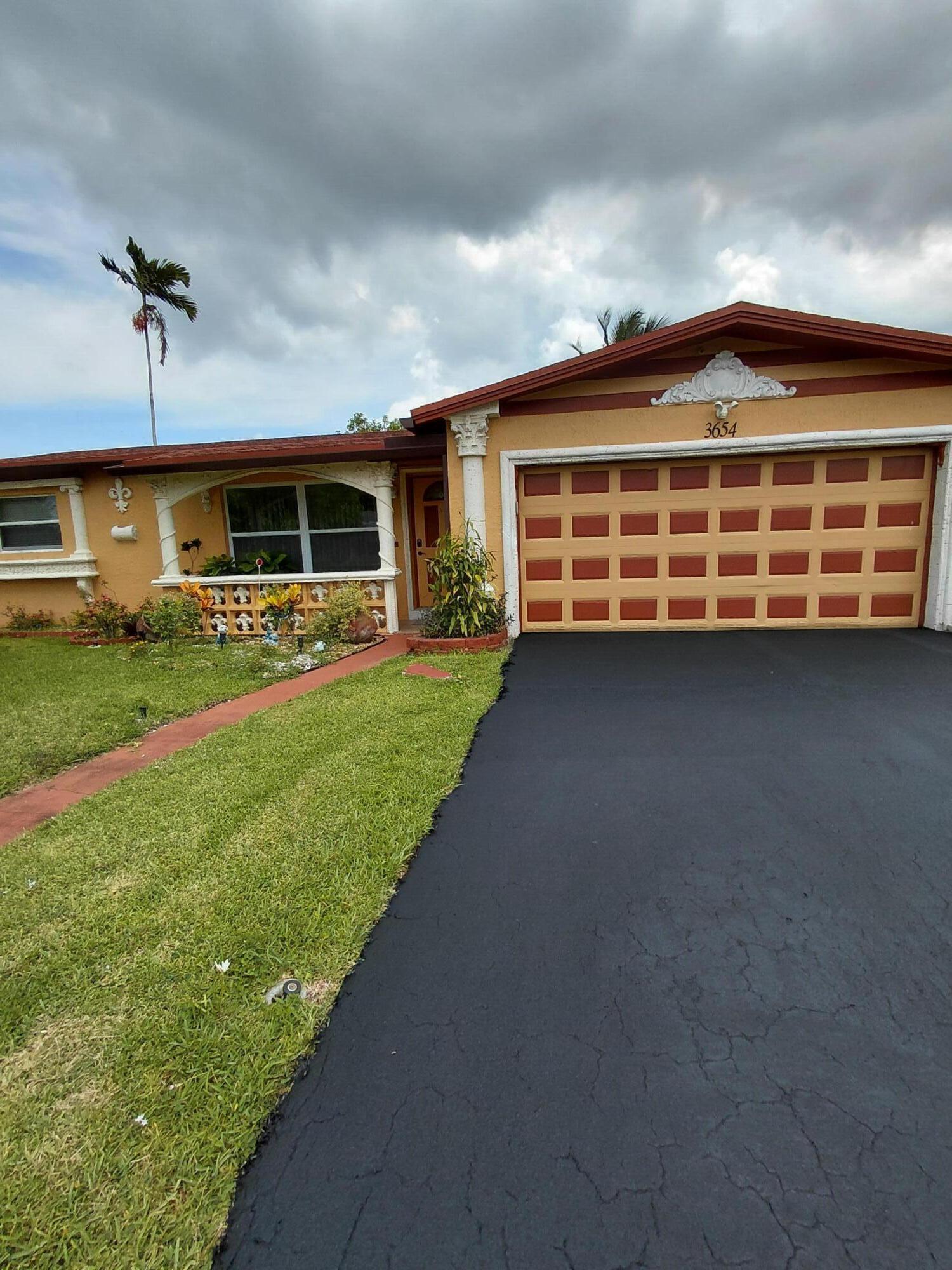 Welcome to this beautiful, spacious 2734 total sq footage  and well maintained 4 bedrooms, 3 bathrooms home in Lauderdale Lakes. Home sits on a spacious  7,700 sf lot and features an additional bedroom, a generous Den and a Jr Suite which can easily generate additional income. Home has impact windows and doors with tile and luxury vinyl flooring throughout. New 2022 roof, A/C 2022 and 2020 water heater with updated plumbing and electrical. Additional features include a two-car garage, a large covered back patio, tropical and exotic fruit trees with water view in the rear. Please call and make your showing reservation for this lovely Home.