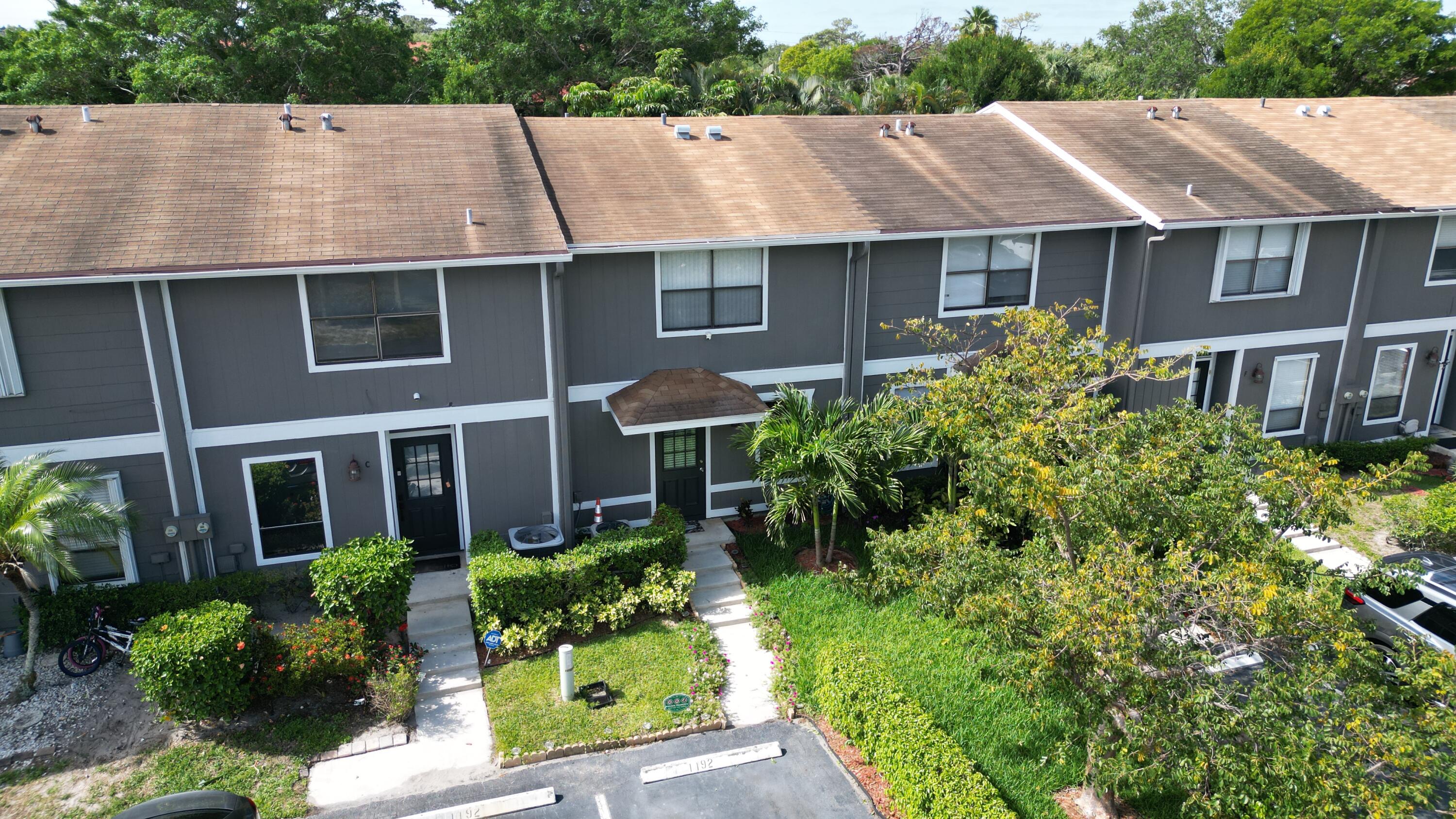 Welcome to this inviting 2-bedroom, 1.5-bath townhouse located at 850 Hill Drive D in the desirable Society Hill Cannongate community of West Palm Beach. Offering 1,044 square feet of comfortable living space, this 1985-built two-story townhome is perfect for first-time buyers, investors, or anyone seeking low-maintenance Florida living. Step inside to find a bright and open layout featuring a spacious living/dining area, a functional kitchen with pantry, and a convenient half bath on the main level. Upstairs, both bedrooms are well-sized, with the primary bedroom offering its own full bath with tub/shower combo. Recent updates include a renovated kitchen and bathrooms (circa 2019), fresh interior paint, and durable upgraded laminate flooring throughout for easy care and modern appeal.  Enjoy the private open patio and garden views, ideal for relaxing or entertaining. Additional features include central air conditioning and heating, ceiling fans, in-unit laundry hookups, assigned parking, and ample storage. Society Hill Cannongate is a well-maintained community with low HOA fees (approximately $85/month) that cover lawn care, pest control, and common area maintenance. The location offers easy access to major roads, shopping, dining, and all that vibrant West Palm Beach has to offer — including beaches, downtown, and Palm Beach International Airport just minutes away. Whether you're looking for a primary residence or a strong rental investment, this townhome delivers comfort, convenience, and value in a quiet, tree-lined setting. Don't miss this opportunity!