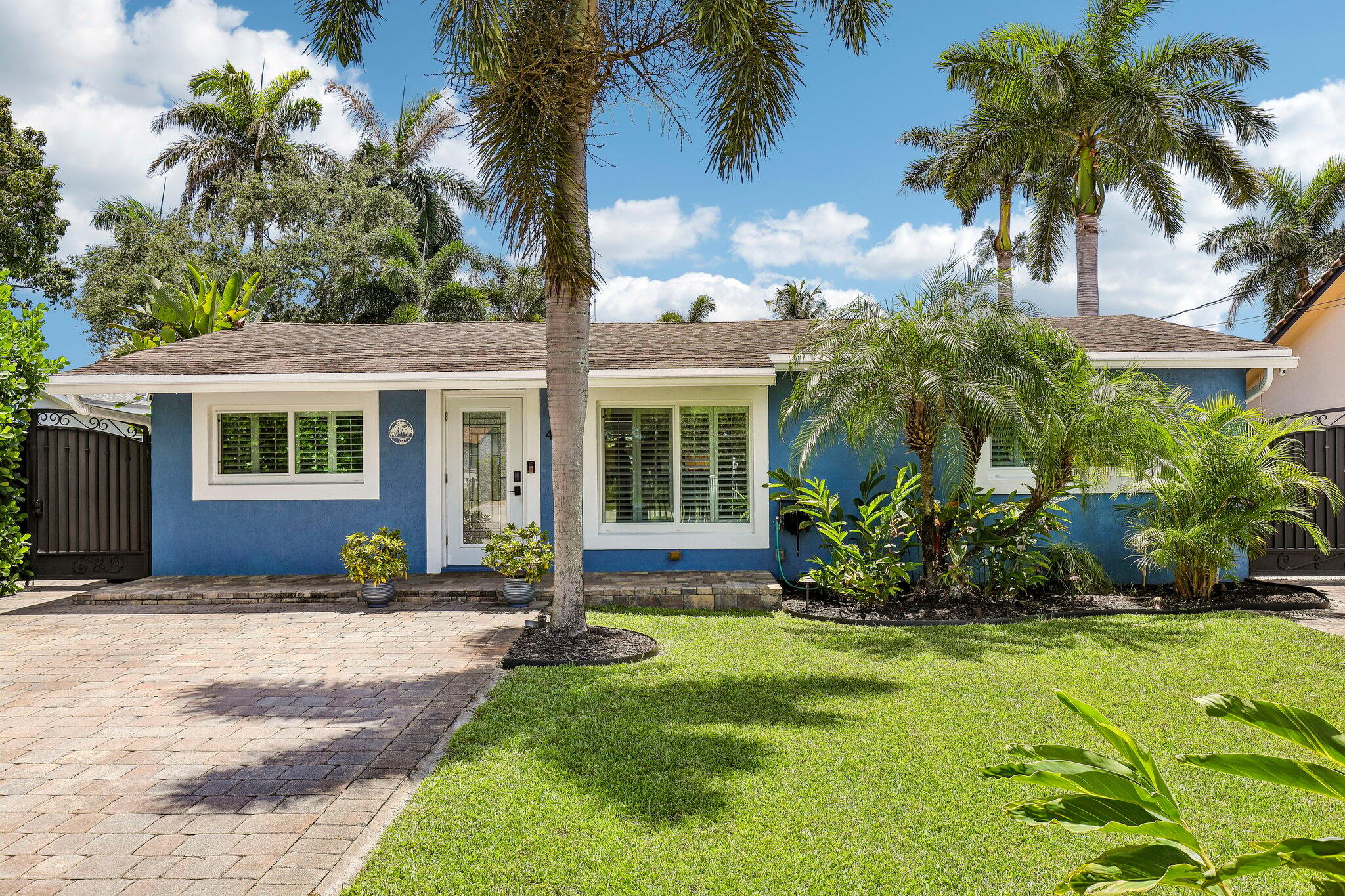 Boater's dream with ocean access & no fixed bridges! This 4/2 single-level waterfront pool home features a kitchen fully redone in 2022 with all new plumbing, electrical & appliances, plus a new washer/dryer. Outside: 70' dock spanning the property line, fully working 16,000 lb boat lift, saltwater pool with waterfall (pump just 2 yrs old) and a recently rebuilt tiki hut covering an outdoor kitchen with running water & electric. Impact windows & doors throughout, huge 15'x30' storage shed, second driveway with backyard access to store another boat, greenhouse, and a tropical yard with mango, banana, dragon fruit & more. New electrical panel, fully fenced with electric gates & security cameras. A true tropical paradise!