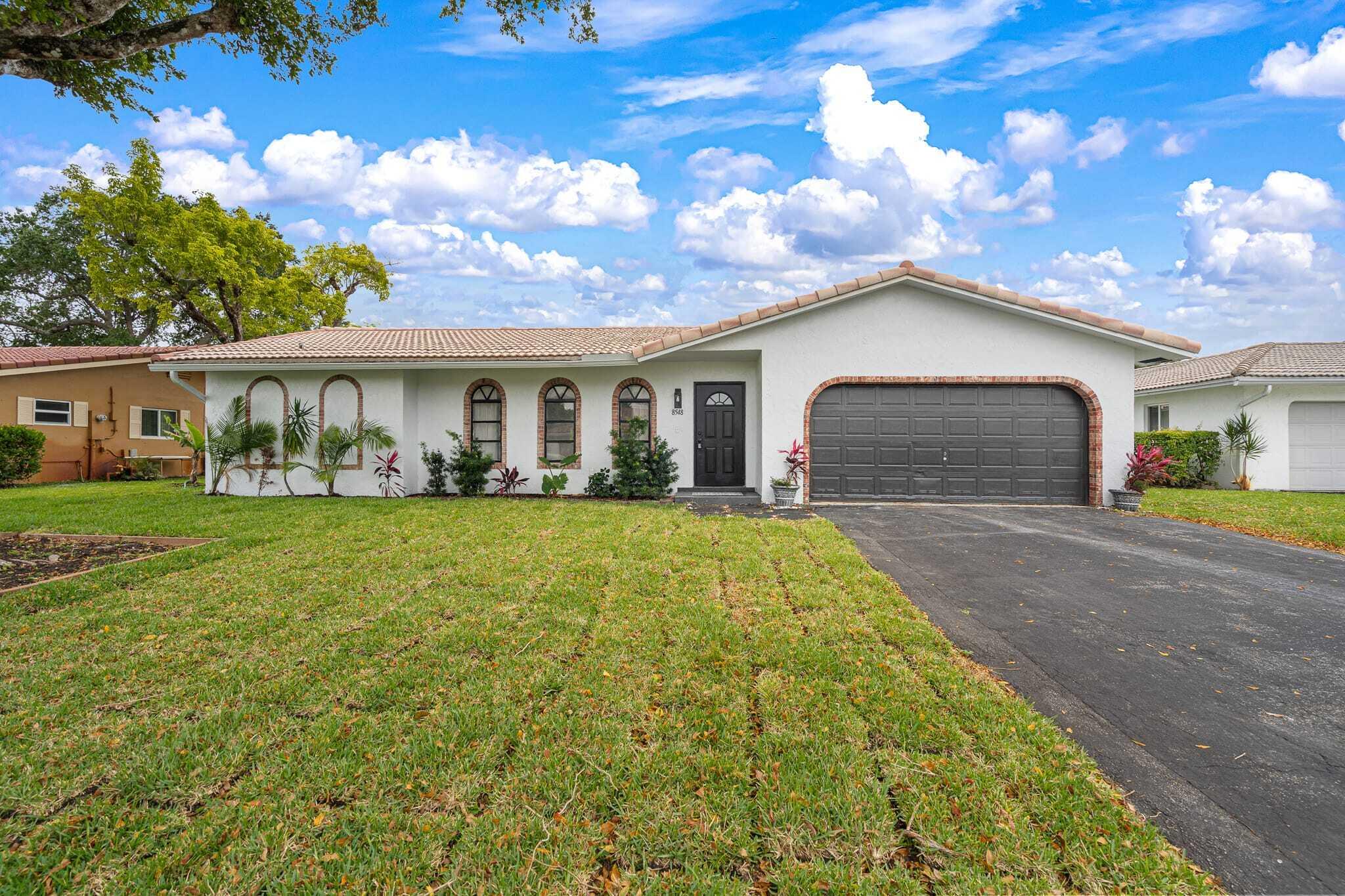 Welcome to this beautifully updated four bedroom Coral Springs pool home, designed with a fresh modern style and an open, inviting layout.  The open concept floor plan connects kitchen to the dining area, family room with stylish featured fire place and main living spaces, creating the perfect flow for everyday living, entertaining and family gatherings.   With updated flooring, fresh paint, contemporary finishes and a clean neutral palette, this home feels elegant , comfortable and move in ready Step outside and enjoy the Florida lifestyle with a beautiful in ground pool and patio area, The expansive pool area offers ample room to design additional outdoor living spaces, giving you endless possibilities for entertainment, relaxation and other outdoor event.
