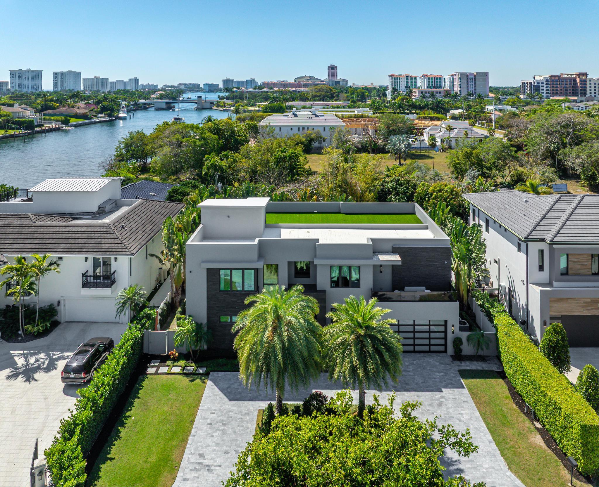Tucked away on the smallest, most private cul-de-sac in Golden Triangle, a dramatic three story contemporary ultra custom residence is right beside Boca Raton's downtown intracoastal waterway. The sleek, modern façade captivates with bold geometric lines, floor-to-ceiling glass windows, a striking mix of smooth stucco and textured stone accents. The grand entrance, framed by custom glass doors and dark stone cladding, sets the stage for the exquisite interiors .Walking distance to the ocean and downtown Boca. East of NE 5th Ave the main house features a two story great room, open kitchen featuring Sub-Zero and Wolf, MAIN floor primary suite and full en-suite bedroom. The second level features three ensuite bedrooms (one currently used as a loft) a full theater, exercise room and office.