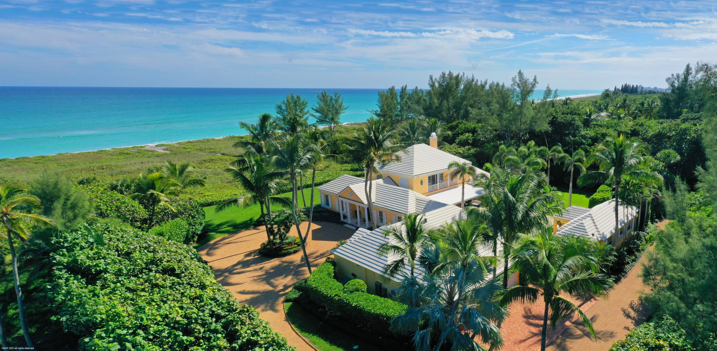 A long winding graveled drive leads to this spectacular Bermuda oceanfront house on 2.7 acres. Designed by famed architect John Volk and impeccably maintained, this Jupiter Island gem is located on 212' of panoramic beachfront. A classic and elegant main house with 2 master bedrooms, has separate guest quarters complete with sitting room and kitchenette. PLUS across the beautiful pool is a two bedroom, two bath cabana/guest house. A large generator ensures an uninterrupted power supply for the entire house. There are endless undisturbed ocean views off both master bedrooms and other living areas of the main house. Perched on a wide protected dune in a very private setting, this quintessential Jupiter Island property offers the best of tropical living.