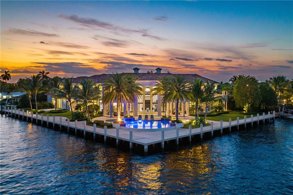 Elegant SE point lot estate in Coral Ridge Country Club! A boater's dream w/190' of side dockage & 140' on the Intracoastal w/accommodation for multiple vessels. Custom designed w/the finest finishes throughout & a light, bright open floor plan. Features include a great room, marble & wood floors, Crestron smart home system, VIP guest suite, gym, club room, loft, theater & elevator. Chef's kitchen w/marble countertops, butler's pantry & high end appliances, open to the family room. Pocket doors seamlessly blend the indoor & outdoor spaces. Large primary suite w/water views, sitting area, dual bathrooms w/soaking tub & spa shower. Outstanding outdoor entertaining space w/multiple covered areas, pool & summer kitchen; the perfect place to enjoy the constant sunny & breezy SFL weather!