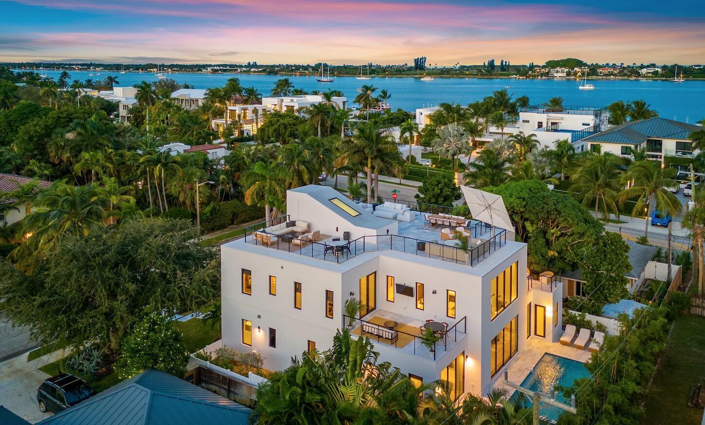 Experience contemporary elegance at 214 28th Street, a sophisticated residence in the highly desirable Northwood Historic District of West Palm Beach. This 5-bedroom, 5.1 bath home combines modern design with exceptional amenities, offering both comfort and style in a prime location. Designed for elevated living and entertaining, the home's defining feature is its expansive nearly 2,000-square-foot rooftop terrace, an impressive private retreat ideal for dining, lounging, and taking in panoramic city and intracoastal views. The interior features a spacious open layout, a dedicated home office, and a luxurious ground floor primary suite with a freestanding soaking tub, designer finishes and his and hers custom walk-in closets. The second floor features four bedrooms each with custom  walk-in closets, along with three private balconies that extend the living space outdoors and create a seamless indoor-outdoor flow.The inviting backyard includes a pool, jacuzzi, and steam room, perfect for relaxation or entertaining. With a two-car garage and proximity to downtown West Palm Beach, the Intracoastal Waterway, and Palm Beach Island, this property delivers the best of luxury living.