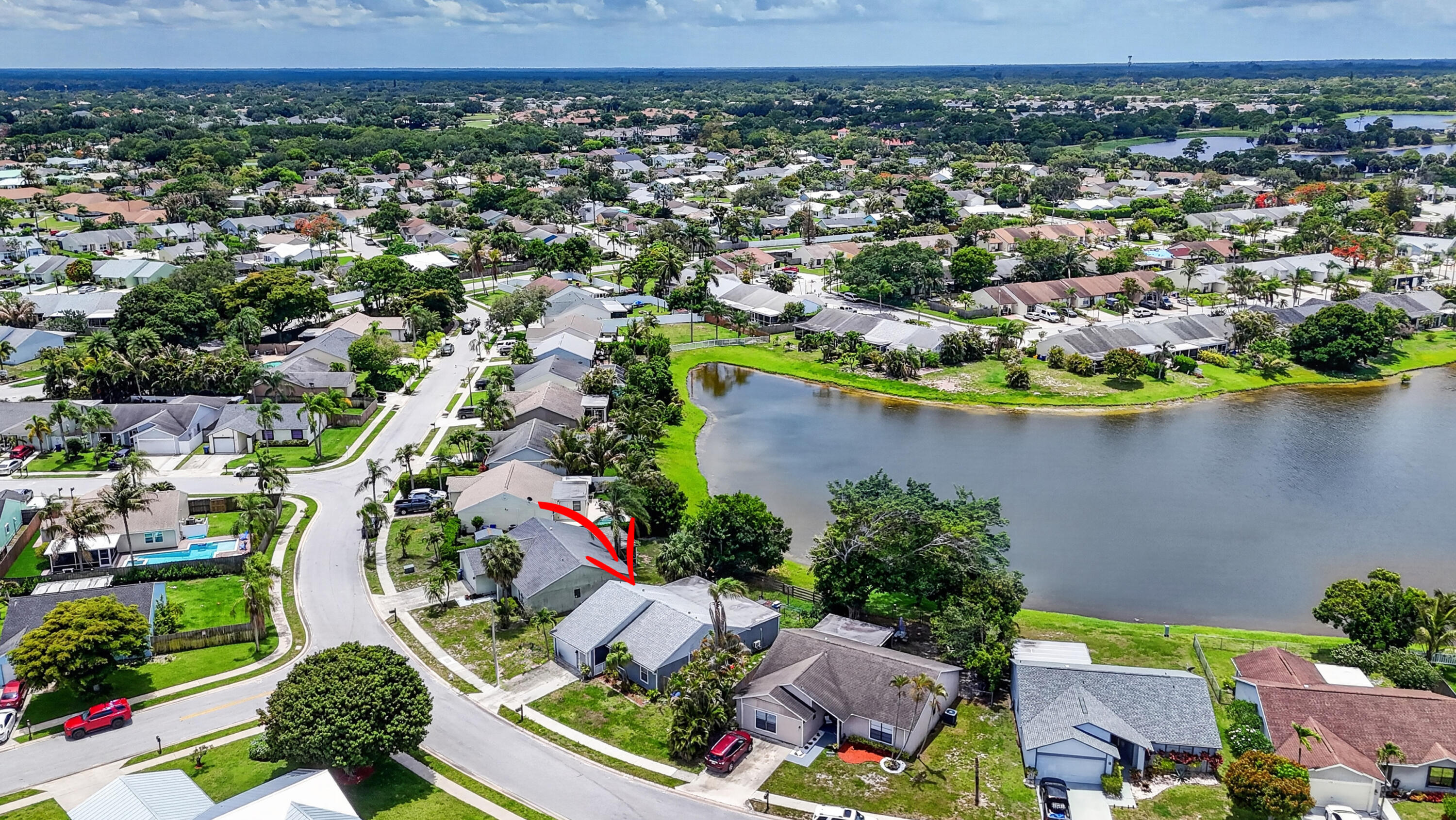 Rare opportunity to own a single-family home with a beautiful lake view in Jupiter Village. Features include a fully fenced yard, 2022 roof, 2021 A/C, and low HOA. The 1-car garage was converted into living space. The large covered patio offers excellent potential to expand indoor living space or create a versatile outdoor space (546 sqft, not included in listed living sqft). Kitchen features stainless steel appliances and granite countertops. Vaulted ceilings in the main living area the overlooks the lake. Primary bedroom includes a walk-in closet. Home also features gutters and a Ring doorbell camera. Great opportunity with minor cosmetic updates needed. Conveniently located near parks, shopping, and restaurants. Community pool included with the HOA.