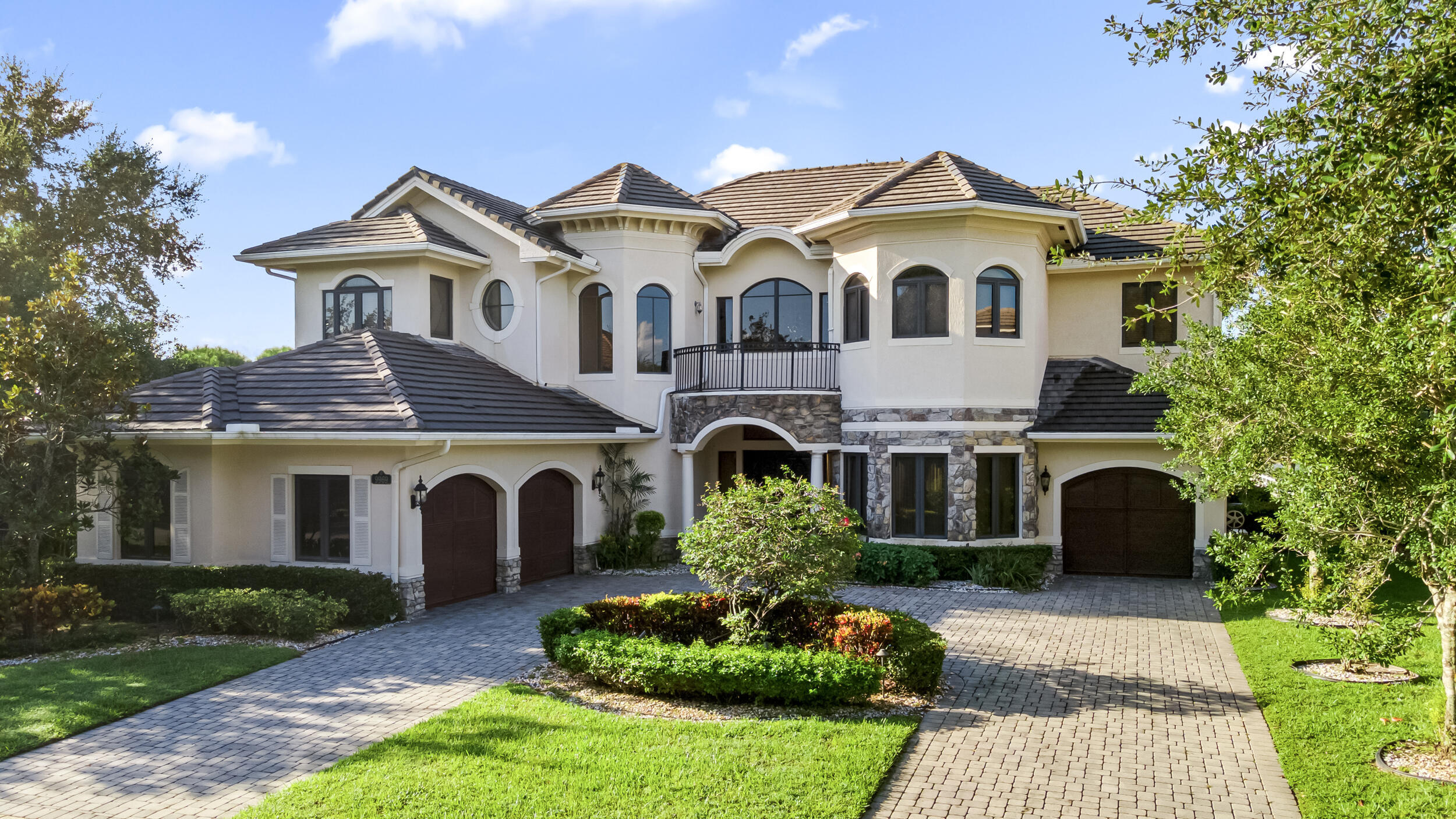 Rare opportunity to own a luxury waterfront estate in the prestigious Equus community at an exceptional value. Situated on over 1/2 acre with beautiful lake views, this impressive 6-bedroom, 7.5-bath residence offers 5,424 total square feet, an inground heated pool, soaring volume ceilings, marble flooring, a grand wrought iron staircase, elevator, gas fireplace, and a custom kitchen with granite countertops. The expansive primary suite features a private balcony overlooking the lake, dual bathrooms, and generous closet space, while four additional bedrooms each offer their own ensuite bathroom. Some impact windows are already installed. This estate presents an incredible opportunity for a buyer to personalize and update the home while creating substantial equity. The property also  includes former horse paddocks. The home is being sold as-is and would benefit from updates and improvements, making it an excellent opportunity for homeowners, investors, or anyone looking to customize a luxury estate in one of Palm Beach County's most desirable gated communities. Equus features approximately 280 estate homes on oversized homesites with tree-lined streets and elegant equestrian-inspired architecture. Residents enjoy a 24-hour manned gate, 7,000-square-foot clubhouse, resort-style pool and spa, fitness center, tennis courts, billiards room, and social spaces. HOA dues include Comcast cable, internet, and phone service.
