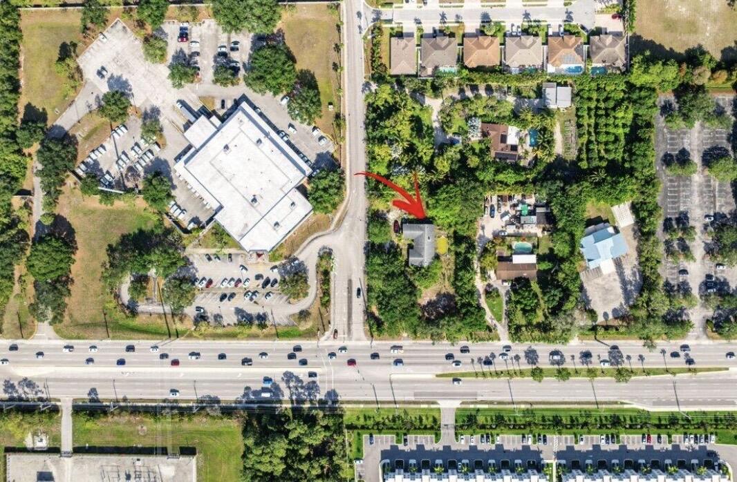 Rare opportunity to own a spacious 4- bedroom, 2 bath home with 3,487 sqf. of living space on nearly one acre in one of Greenacres most strategic locations. While the home offers plenty of space and charm , the true value is its exceptional future potential. Located directly on jog road and surrounded by establishments commercial properties, with the Post Office next door, this property offers outstanding redevelopment possibilities (subj to Zoning and municipal approvals) Potential future uses may include professional or medical offices, retail, mixed-use development, and more. Large parcel with this level of visibility, location and log-term upside are rarely available.