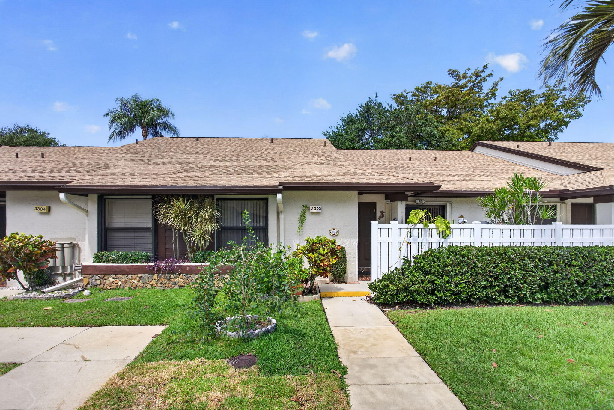 This exceptional 2-bedroom, 2-bath residence is completely move in ready and thoughtfully designed for modern living. The bright, open split floor plan features a spacious primary suite with a large walk-in closet and private access to the enclosed Florida room which offers a large storage closet. The living area also opens directly to this versatile, air-conditioned space, perfect as a den, lounge, or even a third bedroom all while showcasing serene water and greenery views. Sun Guard screens and tinted sliders offer protection from the heat and privacy.   Inside, you'll find vaulted ceilings, elegant wood flooring, recessed lighting, and crown molding that elevate the home style. The kitchen and bathrooms are tastefully updated with wood cabinetry, granite countertops, and Italian ceramic tile. Both bathrooms offer modern finishes and pocket doors providing an en-suite experience. Stainless steel kitchen appliances are just 2 years.   Packed with upgrades: impact front door and bedroom window, accordion shutters (2018), surge protected electrical panel, remote controlled ceiling fans, and outdoor floodlight with auto sensor, plus all permits in place. Major improvements include a brand-new roof with wind mitigation (2025), A/C (2018), water heater (2017), and nearly new washer and dryer.  Step outside to enjoy two private patios front and back perfect for entertaining, relaxing, or soaking in the tranquil waterfront setting. Ideally located near shopping, schools, major highways, and everyday conveniences.  Quarterly HOA is $2,150 (includes roof loan) plus $189 master association. Cable included, with internet coming soon.  This is the kind of home buyers get excited about, don't miss the opportunity to see it in person!