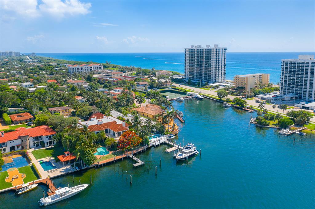 Cast against one of the most picturesque backdrops in all of Palm Beach County, this sprawling Provence-inspired masterpiece on Lake Boca Raton thoughtfully bridges the worlds of artisanal splendor and contemporary comfort. Set in Por la Mar, one of the most quaint communities in Boca Raton, this epic six-bedroom property (with seven full baths and two powder rooms) encompasses 17,114 square feet—including 12,101 square feet of living space. In addition to being ideally positioned along 120 feet of protected deep-water dockage, boating enthusiasts have direct ocean access through the Boca Inlet. Better still, the quiet lakefront setting, which overlooks the Boca Raton Resort & Club, is a luxury enclave unto itself. That thread extends past the soothing outdoor fountains that frame the bluestone walkway leading to the front doors. Originally built by Mark Timothy Inc. in 2003 and designed by Marc Michaels, the two-story estate, with tropical grounds manicured and landscaped to perfection, recalls a lavish villa along the French Riviera. Exquisite interior details only add to the drama. The formal living room features soaring ceilings and a two-story, wood-paneled fireplace with onyx inlay; a second living room boasts a pecky cypress ceiling and a sit-down, granite-topped wet bar. An entire main-floor wing is devoted to the master suite, which opens to a private loggia overlooking the lake. The wing also includes an exercise room, separate his and her baths, and separate custom-designed closets (including a designer accessory island, shoe backlighting and a private courtyard window in her closet). Marble countertops, custom stone flooring and state-of-the-art appliances are among the highlights in a gourmet chef's kitchen with an oversized island and butler's pantry. Nearby is a brick, temperature-controlled wine room that conjures images of a Tuscan cellar flowing with vintage selections. Another highlight of the main floor: a two-story library with exquisite millwork, built-in bookcases on both levels and a hidden spiral staircase. Along with the four additional bedrooms (each with marble baths, separate soaking tubs and lakeside balconies), the second floor features a private clubroom with a media lounge, billiards table, full-service bar and poker table area. The adventure continues outdoors with spaces perfectly rendered for entertaining, starting with a sweeping wraparound loggia and brick terrace. A resort-style lagoon pool and waterfall spa, beautifully encased by lush green foliage, offer privacy without diminishing the lakeside views.