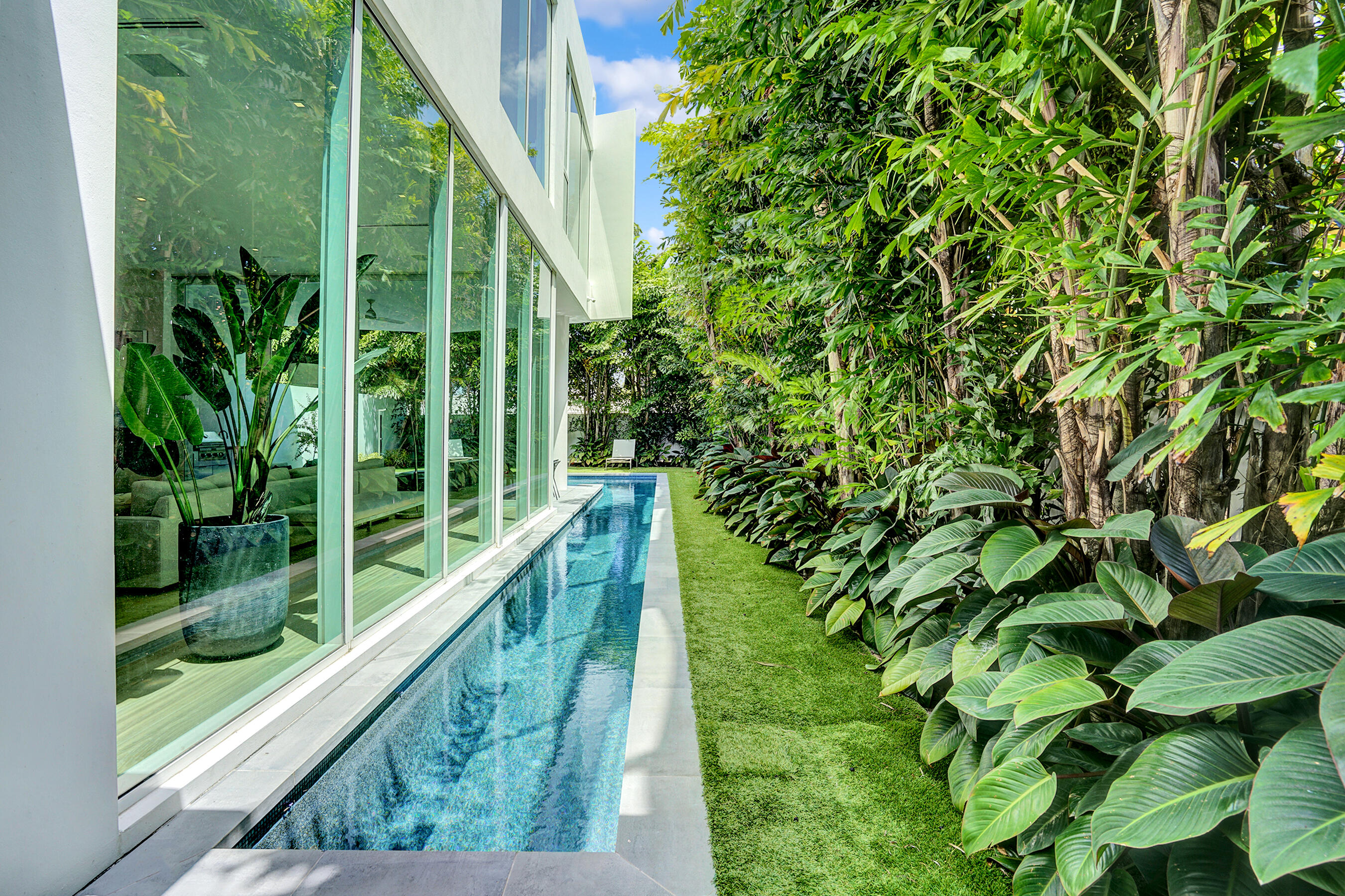 Indulge in the pinnacle of luxury living in this recently completed modern masterpiece! Nestled in the prestigious Palm Trail neighborhood, just two blocks from Atlantic Avenue and a leisurely stroll to the beach, this striking modernist home embodies sophistication at every turn.
Crafted by the esteemed Azure Development and renowned architect Jeffrey Silberstein, this two-story sanctuary spans 3,982 square feet under air, boasting a total of 5,090 square feet. Revel in 4 bedrooms,4 and a half baths, a spacious club room, an oversized two-car garage, and an exclusive gated motor court entrance. Step into your private oasis with a sprawling wrap around pool and meticulously landscaped gardens.Experience the epitome of openness and light with 12-foot high floor-to-ceiling glass all around The floor plan exudes openness and light with 12-foot high floor-to-ceiling glass on the ground floor and skylights illuminating every corner. Entertain effortlessly as expansive glass sliding doors seamlessly blend indoor and outdoor spaces. Upstairs, 10-foot ceilings and floor-to-ceiling windows elevate the ambiance.

No detail has been spared, with top-of-the-line amenities including Sub-Zero and Wolf appliances, a Sub-Zero wine refrigerator, Electrolux washer and dryer, Trane/American Standard HVAC system, Icynene insulation, and a natural gas tankless hot water heater. Enjoy the tranquility of Quietrock sound-suppressing drywall and the convenience of Savant smart home technology. Generac Generator.

Luxuriate in floor-to-ceiling cabinetry, a morning bar, a saltwater pool with gem finish and sheer descent, a summer kitchen, a natural gas fire pit, Emtek hardware, and custom millwork. Italian porcelain graces all wet areas, while 9-inch wide wire-brushed white oak flooring exudes elegance throughout.

Welcome home to unparalleled luxury and refinement, a haven where every detail is crafted to exceed your highest expectations.
