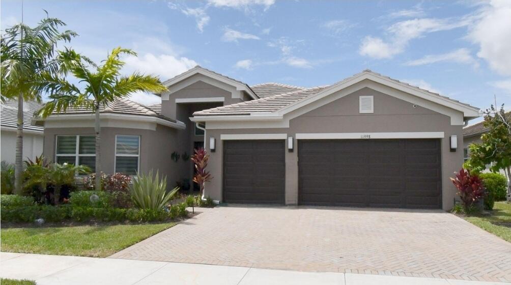A rare opportunity to own a masterfully designed contemporary estate where sophistication meets comfort. This 3Br 3.5Bth architectural showpiece features soaring ceilings and seamless indoor-outdoor lifestyle with elevated waterfront living. Designed for both grand entertainment and intimate relaxation, this home boasts an open-concept floor plan with designer finishes. The chef's kitchen appointed with top-tier appliances, custom cabinetry and an island perfect for entertaining, flows effortlessly into expansive living spaces & out to a private  outdoor oasis featuring a summer kitchen, pool and spa. The expansive primary suite offers a spa-inspired bath. Located in an exclusive gated active adult community near premier dining, shopping and much more, this home delivers refined luxury at every turn. A true sanctuary offering elegance, privacy and unparalleled lifestyle. Guest will enjoy 2 additional ensuite bedrooms and a den for additional entertainment or optional 4th bedroom. This Julia Model home also offer a 3 car garage, an oversized laundry room with soaking tub & powder room. This home also has Solar Panels and equipped with a Generator. Nestled in the highly coveted Valencia Grove at Riverland in Port Saint Lucie the community  offers a 34K SF Clubhouse with a pool, full-service restaurant, card rooms, and billiards. The Arts & Culture Center features art, pottery, and cooking classes, while the 24-acre Sports & Racquet Club boasts a 51K SF Wellness & Fitness Center.  Riverland boasts the largest Pickleball facility with over 50 Pickleball Courts, Tennis Courts, Bocce and so much more. COME ON HOME TO VALENCIA COVE AT RIVERLAND!!!
