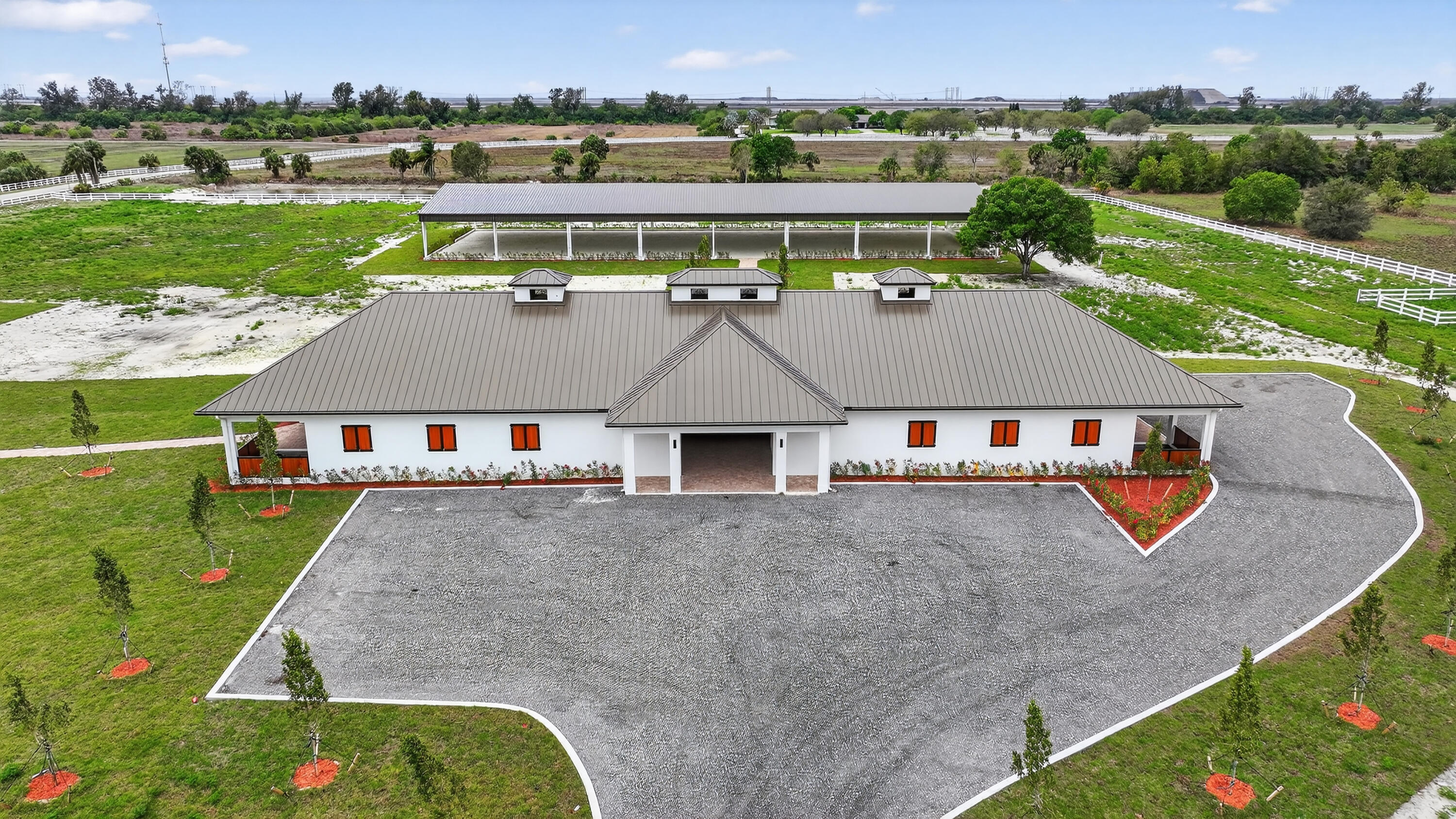 Exceptional new construction equestrian estate  The property features single-family home and a fully equipped horse facility with 12 stalls, rider's lounge with guest room, 1.5 baths, office, laundry, tack room, and a covered arena with lighting and training mirror.The main residence offers 4 bedrooms, a den/office, and an open-concept design. The gourmet kitchen boasts Taj Mahal quartz countertops, Thermador appliances, induction cooktop, custom-panel refrigerator, and custom pantry.  custom closets, ceramic tile, impact windows and doors, and a whole-house reverse osmosis system.Outside, enjoy a pool and spa, outdoor kitchen with BBQ and wine cooler, paver walkways, and a fully fenced property with gated entrance, combining luxury living with an exceptional equestrian lifestyle. WHITE FENCES EQUESTRIAN ESTATES  GATE code is 5698. Seller will pay 6 months of HOA after purchase.