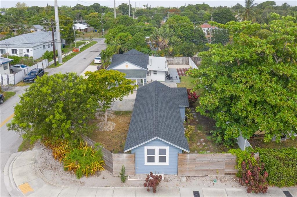 Incredible opportunity to purchase this spectacular property with two homes on one lot. Phenomenal curb appeal situated on a large yard, fully fenced for privacy. The 2 bedroom, 2 bathroom main house features a new clean and modern kitchen, new bathrooms, and plenty of living space. The adorable guest house is a 1 bedroom and 1 bathroom cottage with an updated kitchen and separate living area.  Both homes have new roofs and impact windows. Make this charming home your own or use it to generate rental income. Conveniently located close to shopping, dining, downtown, beaches, and parks.
