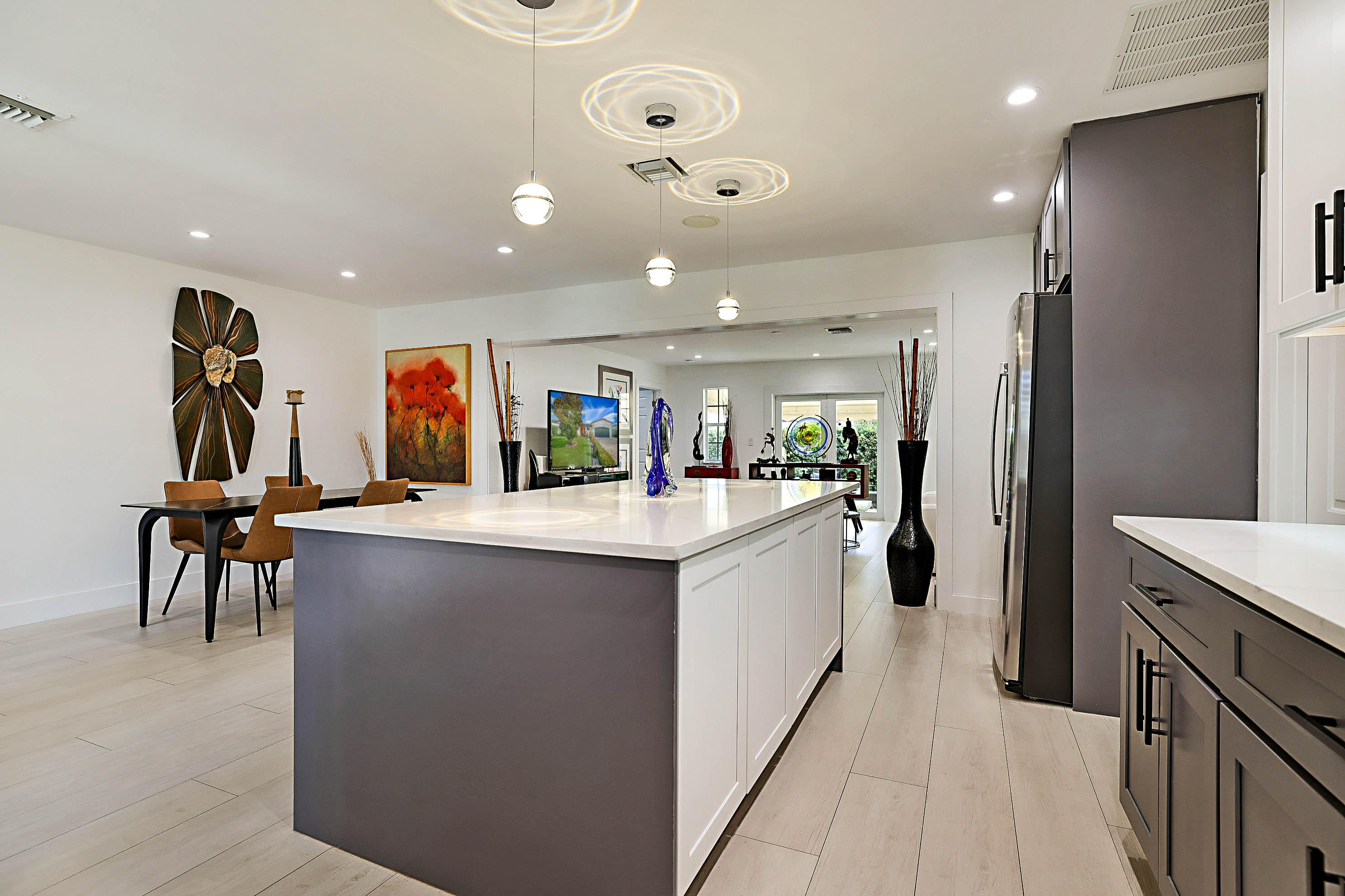 Looking for a spacious, fully remodeled 4-bedroom home East of US-1? Your search ends here! Ideally located between highly desirable Deerfield Beach and Lighthouse Point, this stunning residence is just minutes from the Intracoastal, beautiful beaches, dining, shopping, and entertainment. This beautifully updated 4-bedroom, 3-bathroom home showcases a brand-new designer kitchen featuring a large center island perfect for entertaining, quartz countertops, and stainless-steel appliances. Enjoy new porcelain tile flooring throughout, along with beautifully renovated bathrooms featuring modern vanities and spa-inspired showers with elegant tile finishes. Major improvements provide added peace of mind, including a roof installed in 2019, new A/C system, and impact glass windows and doors.  Additional features include high-hat lighting throughout, a paver driveway, and a spacious 3-car garage as one side is tandem. Step outside to a fully fenced backyard retreat offering a peaceful, Zen-like atmosphere with a covered awning for shade and relaxation and room to add a lap pool. The oversized side yard provides room for a trailer, boat, or additional storage possibilities. Excellent location east of Federal Highway, just minutes to beaches, waterfront living, restaurants, and shopping—this move-in ready home offers the perfect combination of location, style, and lifestyle.