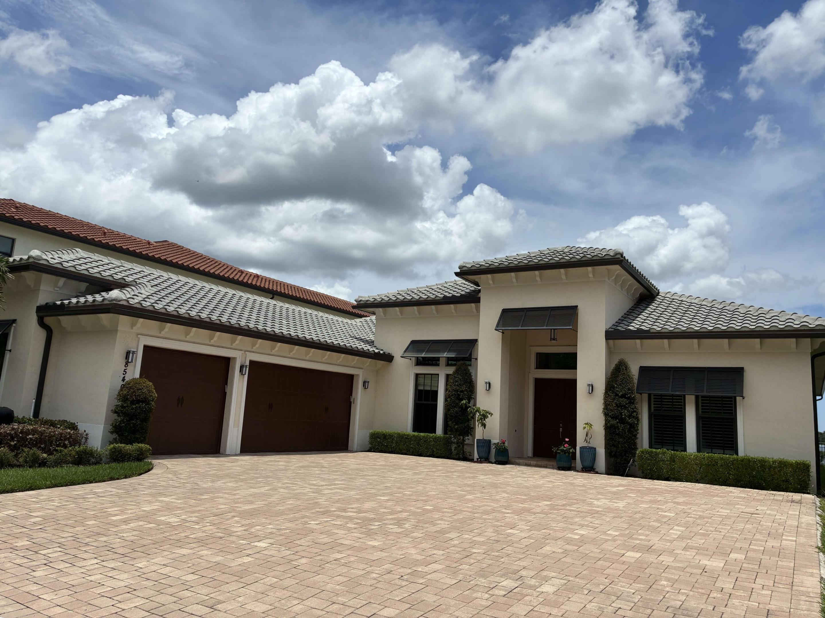 The largest single-story house in on the shore of the biggest lake in Broward County! 4069 SQ ft of living space with 13' ceilings, spectacular views, 4 bedrooms, 4 full and 1 half bathrooms. Flexible open floor plan accommodating a formal dining room, office and endless recreational space. Over $350K in upgrades including a unique layout change creating an expanded, self-contained mother-in-law suite out of the original largest guest bedroom, complete with full kitchen (perfect for a kosher setup or for extra cooking area capacity)! Main kitchen has French cabinetry with Italian doors and Spanish tile backsplash. All lower cabinets have pullout drawers (not hard-to-reach fixed shelves). All counters are highest grade quartz with center island waterfall.  The main kitchen centerpiece is all-Viking, top of the line appliances, including an under-counter wine fridge and separate built-in freezer and fridge units. Custom lighting and ceiling fans in every room. No carpeted floors - all tile in every room. Most windows have top-of-the-line plantation shutters with hidden hinges. Outside Florida room is enclosed with a mesh screen to keep unwanted pests out of your outdoor relaxation space. A spacious attached 3-car oversized garage and a driveway easily accommodating up to 8 cars provide ample vehicle room for your family ang guests
