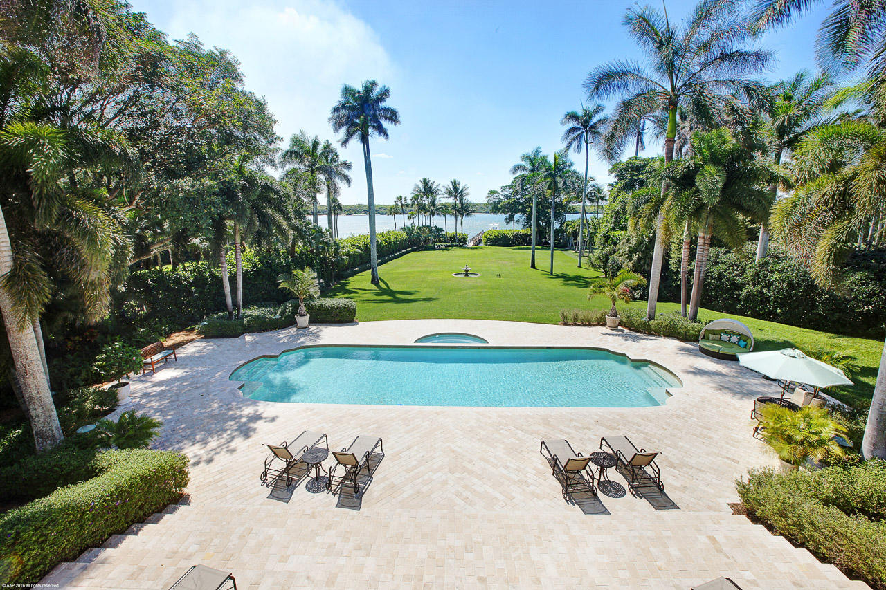 Updated in 2007, this spectacular Intracoastal property sits on two lush, landscaped acres with glorious wide water views across to the nature preserve. The 9,000 s.f. main house has been meticulously maintained and includes 7 bedrooms and 8 full baths. In addition there are separate one bedroom guest/staff quarters with a large kitchen and sitting/dining area. A covered outdoor terrace overlooks a luxurious pool and spa with a sweeping lawn down to the water. A deep water dock and deeded ocean access make this a truly exemplary estate.