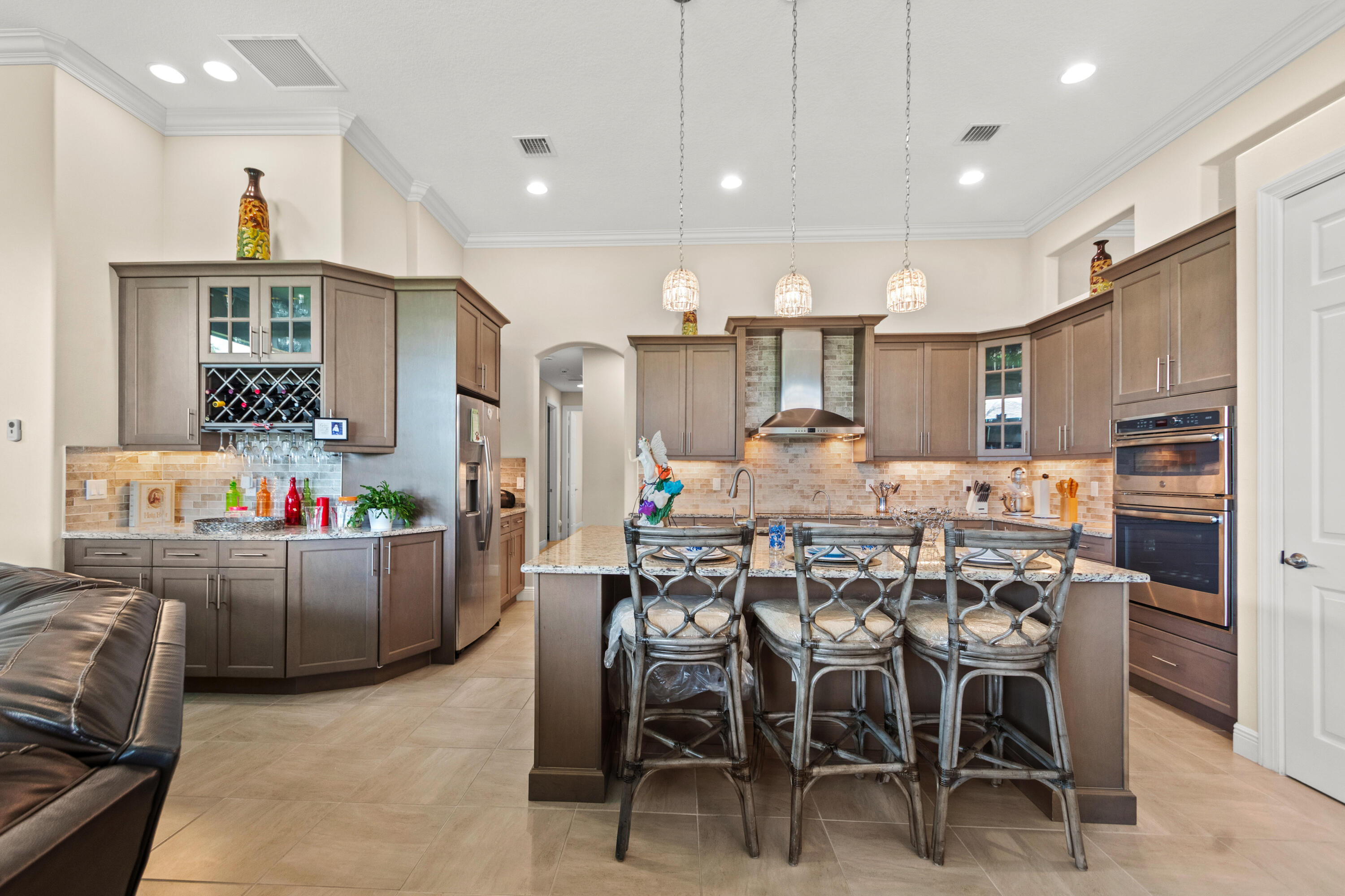 Spacious and award-winning GHO Sawgrass floor plan offering nearly 3,000 SF under air with 3BR + den, 3BA, and a true split-bedroom design for privacy. The open-concept great room flows seamlessly into an oversized chef's kitchen featuring a massive island, café dining area, and formal dining room. Luxurious owner's suite with dual walk-in closets and spa-style bath. Enjoy Florida living with a large covered lanai, impact glass, concrete tile roof, and premium estate-level finishes throughout.