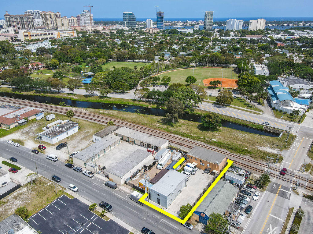 Freestanding two-building commercial property in West Palm Beach's rapidly growing Warehouse District, just steps from Grandview Market and minutes to Downtown West Palm Beach, Palm Beach Island, and I-95. The front building (approx. 2,080 SF) features a large front office with half bath on the first floor and a spacious second-floor office with full bath. The rear portion includes a loading area, full bathroom, storage, utility space, and additional second-floor storage. The back building (approx. 1,960 SF) offers office space, open work areas, storage, and full bath on the first floor, with a large second-floor storage or work area above. Total approx. 4,040 SF.Excellent opportunity for owner-users, showroom, catering company, or investment in a rapidly growing commercial district.