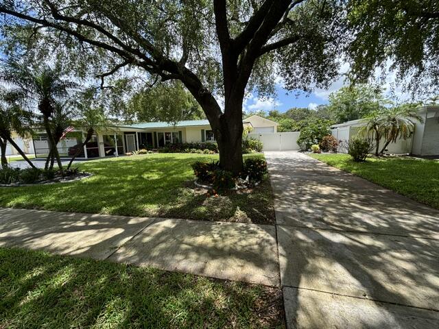 Nestled in desirable Plantation, known for its tree-lined streets, parks, and convenient South Florida location, this versatile one-story home offers 4 bedrooms, 2 bathrooms, 1,784 square feet of living space, and no HOA. Professionally landscaped grounds with a tranquil waterfall feature create inviting curb appeal, while the interior features tile and laminate flooring throughout and abundant natural light. Major upgrades include Anderson impact windows, a metal roof (2019), newer gas water heater, exterior paint updates, and a 22kW Kohler whole-house generator connected to natural gas. The private backyard retreat features a resurfaced Diamond Brite pool with new tile, a new pool heater, and a fully fenced yard with double gate access.  Additional highlights include a 2-car attached and screened carport and a detached 660-square-foot garage with potential for a guest suite, pool house, home office, in-law quarters, or possible rental opportunity. With ample parking and exceptional versatility, this property presents a rare opportunity in Plantation.