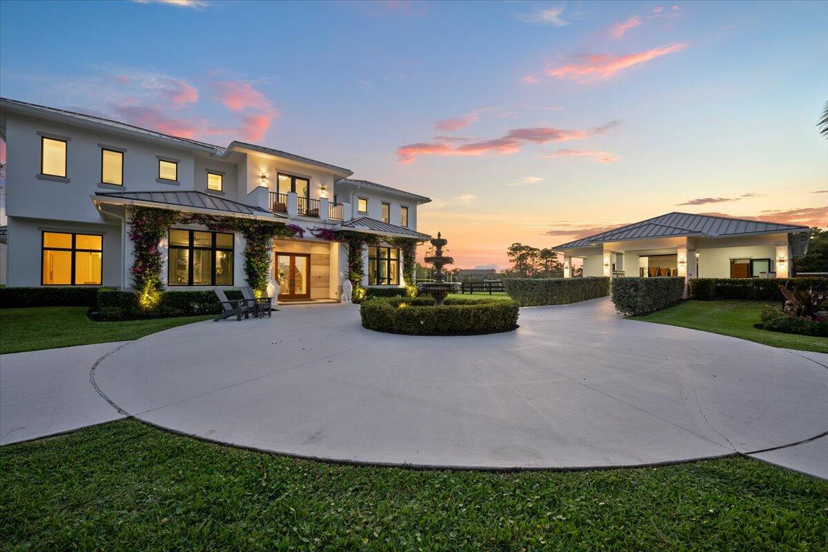 Imagine waking up to a gorgeous sunrise on your private 5 acre horse farm in the gated equestrian community of Homeland, just 10 minutes from Wellington International Show Grounds. This new construction house and barn (2020) has two master suites (one up/one down), with many options to customize the space to best suit your own needs. The barn was recently customized to accommodate 8 horses plus a tack room and feed room, not to mention 4 wash stalls, an ebb and flow ring, and a viewing pavilion. Additional amenities include a private tennis court, a practice sport field, a screened pool/spa plus cold plunge and outdoor kitchen, fully gated property (3 electric gates), air conditioned garage, full home generator, elevator, two laundry rooms (upstairs/downstairs), and all impact glass.