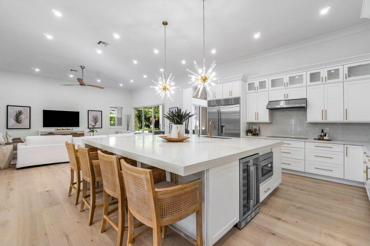 Introducing 5745 Native Dancer situated in Steeplechase, an exclusive gated, luxury community in Palm Beach Gardens where all homes are on at least an acre.

Welcome to a magnificent, stunning light and bright south facing completely reimagined renovated property! This 5 bedroom plus office, 5 1/2 bathroom residence offers 4,452 square feet of living space all on one story on a sprawling 1.18-acre beautifully landscaped, private property. Every detail has been meticulously crafted to create an exquisite living experience that rivals a luxury resort. Step inside to discover an array of impressive features including, but not limited to, a brand new roof with a transferable warranty, new impact glass windows and doors, hurricane rated garage doors, gorgeous wide plank light oak wood floor a state-of-the-art kitchen presenting Sub-Zero stainless steel refrigerator, Bosch dishwasher, Wolf electric range & double oven and other upgraded appliances.  This spectacular renovation also includes 3 new Carrier ACs, a luxurious primary suite with a spa-like bathroom boasting a relaxing free standing modern tub, beautiful custom cabinetry with quartz countertops and a separate water closet with Toto toilet.
When outdoors the lucky new owner can enjoy the huge, lushly landscaped backyard from their beautifully renovated and resurfaced pool with new heater, new filter, and a new chlorine system and a fabulous new summer kitchen with quartzite counters. Too many improvements to mention all.