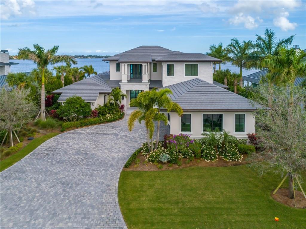 Rare opportunity in ''The Floridian'', an exclusive National Golf Club. Built by Straticon, the elite in custom construction, & interiors designed by renowned Pineapple House of Atlanta, the finishes are unrivaled. Exquisite open floor plan with dramatic views of the Saint Lucie River. Reclaimed oak floors, designer lighting, custom marble, cement tile, gourmet kitchen with Wolf & Sub Zero, butler's pantry, wine/beverage center, & extensive woodwork throughout. Custom office with bar could serve as 5th BR. Private first floor master suite. Upstairs: 3 BR with ensuite baths plus sitting area/family room. Expansive loggia with outdoor kitchen, gas fire pit, and resort style pool. Impact doors and windows. The Floridian offers full Concierge services. Club Cottages for guests, private wine room, spa, fitness, tennis, & helicopter pad. Premier location allows access to the World's Top Destinations by water as the marina RIVALS the world class golf - accommodating vessels up to 150'.