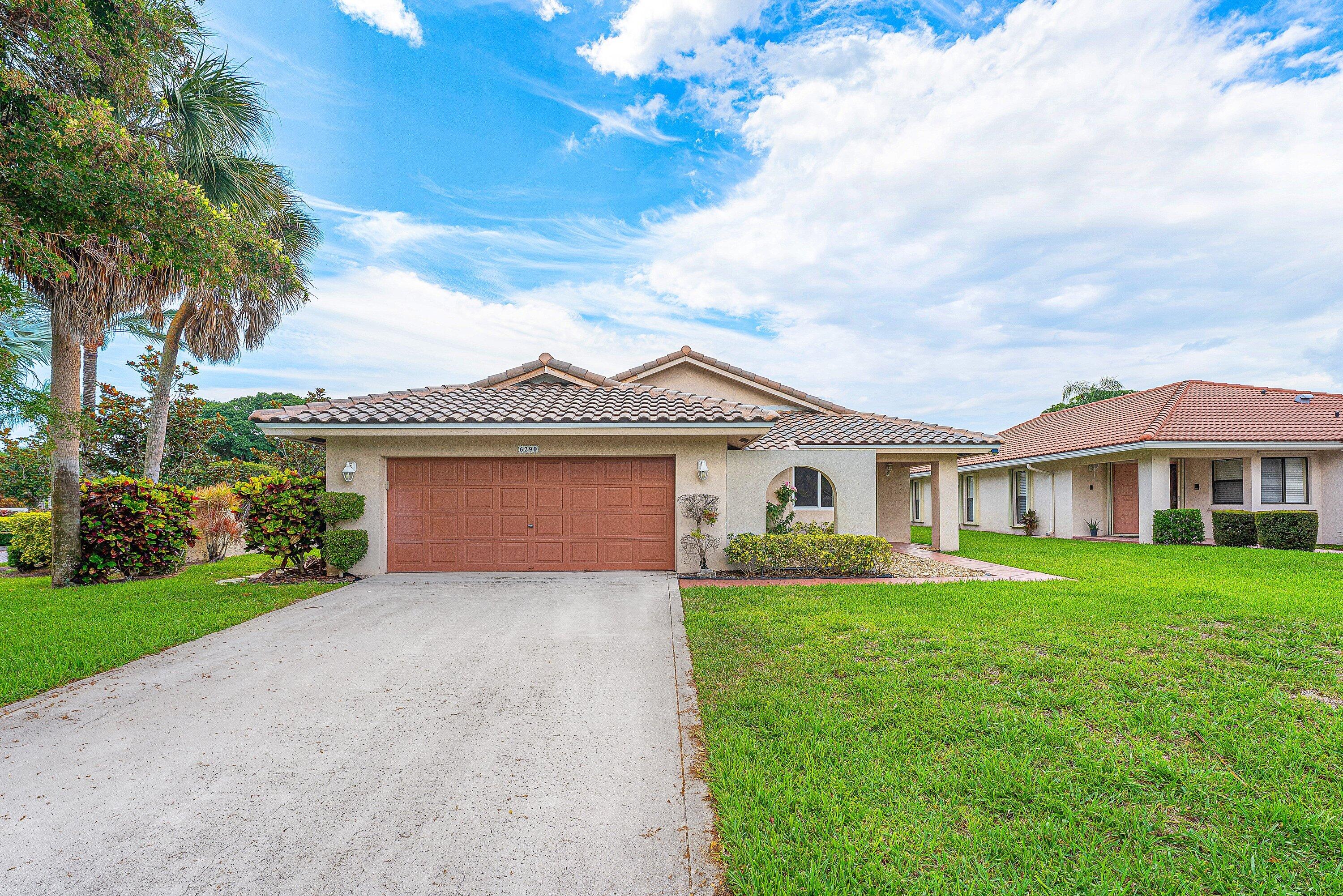 Exceptional move-in ready 3-bedroom, 2-bathroom - split floor plan - single-story home situated on a desirable corner lot in the highly sought-after Vista Verde community. This light-filled residence features an open and airy floor plan with vaulted ceilings, a spacious living room, formal dining area, and a comfortable family room that seamlessly connects to the eat-in kitchen. The kitchen is equipped with stainless steel appliances and offers the perfect setting for everyday living and entertaining. The primary suite features a walk-in closet and an updated private ensuite bath. Recent improvements include a NEW roof (2026), NEW wood-look oak tile flooring in the primary and second bedrooms, updated bathrooms, new closet doors, fresh interior paint throughout, a newer tankless water  heater, and a newer 3-ton A/C system (2025). Hurricane protection includes impact windows and sliders, along with shutters for the glass block accents and front door. Ideally located in the heart of Boca Raton, Vista Verde offers exceptional convenience with a short walk to Town Center Mall, Publix, A-rated Verde Elementary School, and multiple houses of worship. The low HOA fee includes lawn care and sprinkler maintenance, providing easy, low-maintenance living. A rare opportunity to own a beautifully updated home in one of Central Boca's most desirable neighborhoods.